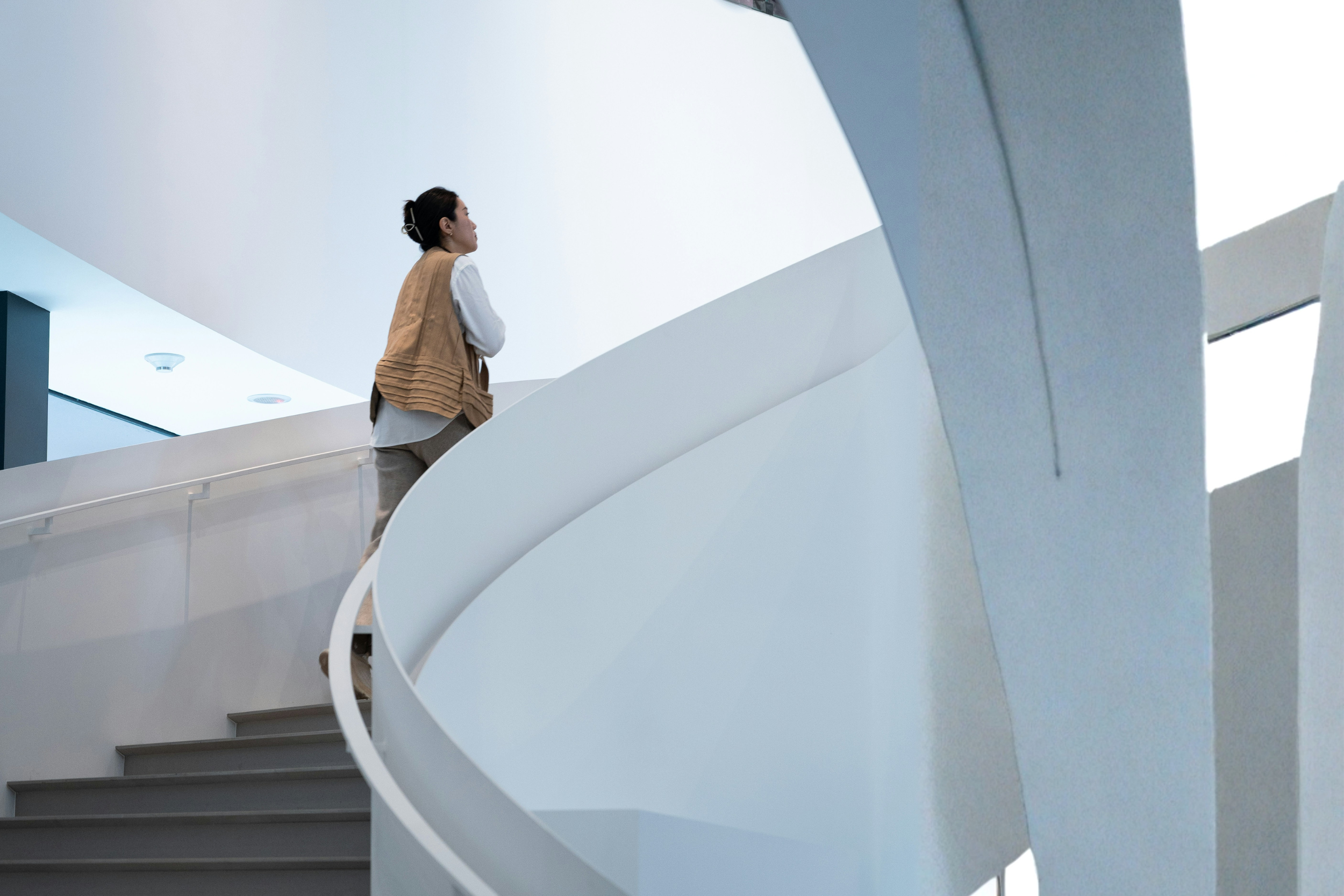 asian woman walking up stairs