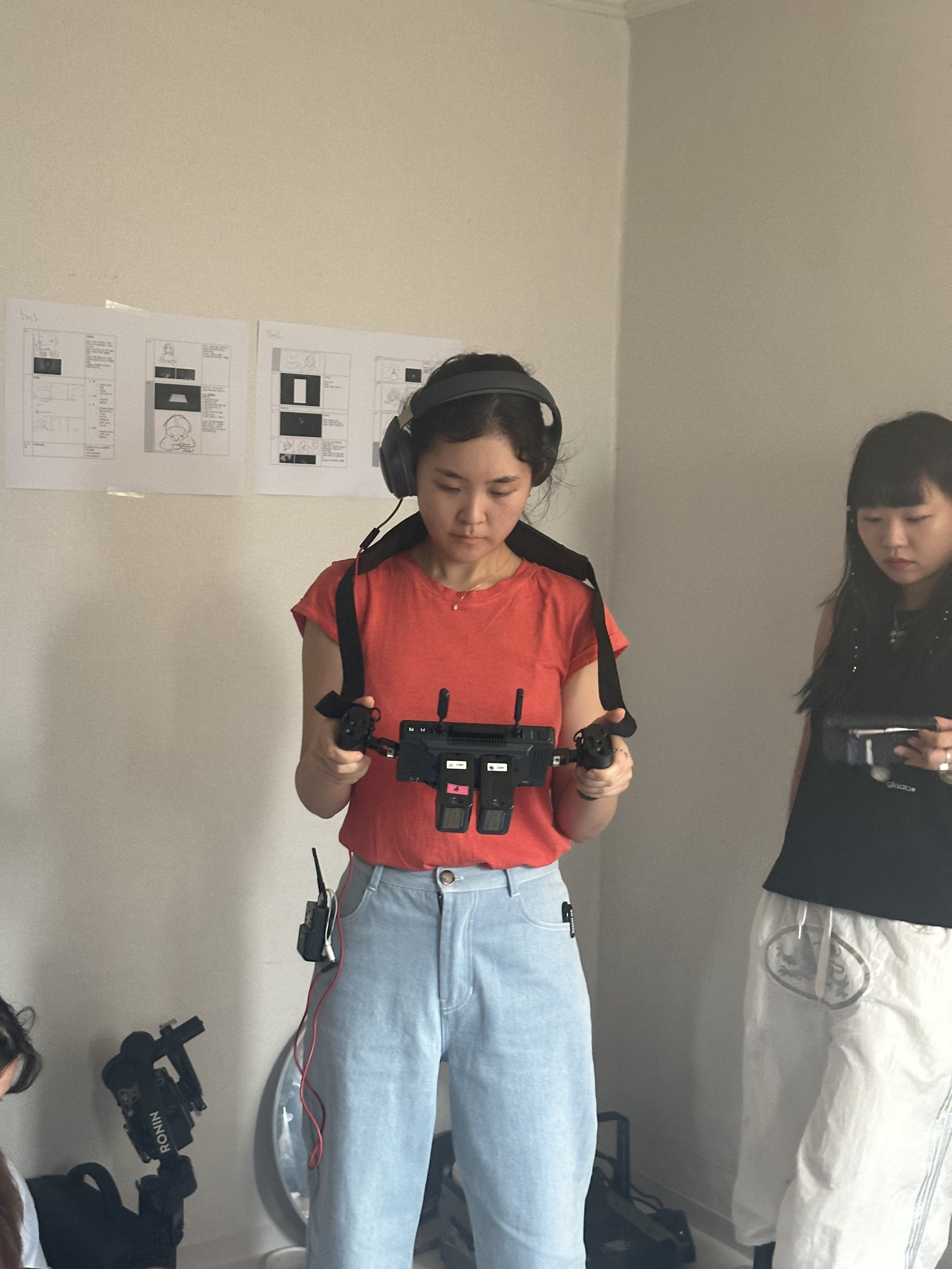 Swipe Right To Bite/SRTB behind the scenes/BTS. Director Yuchae reviewing footage on monitor.