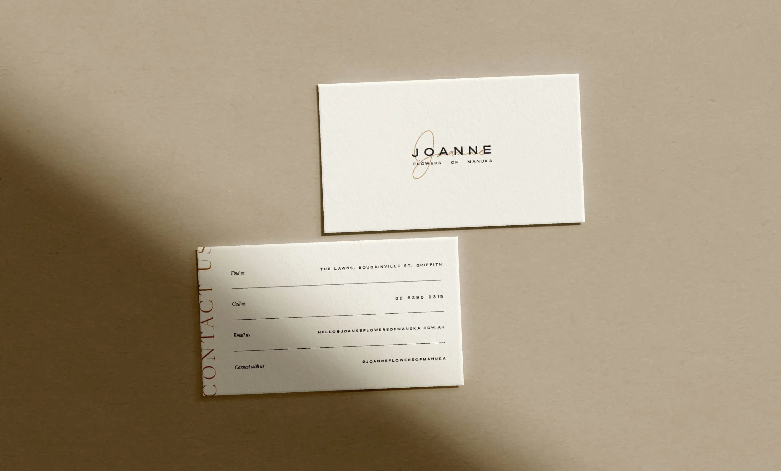 Business card and matching sticker for Joanne Flowers of Manuka, featuring contact information and design elements on a beige background.