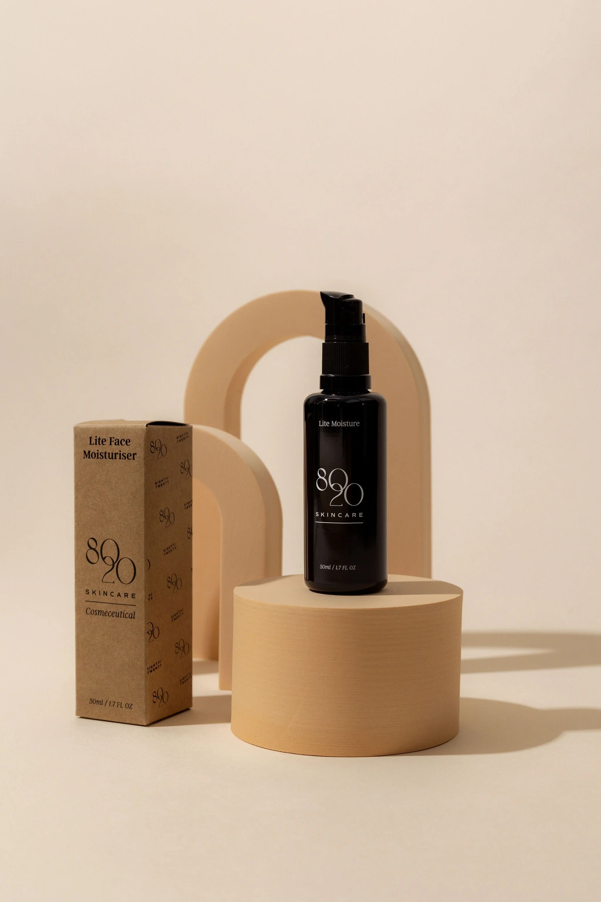 Skincare product display with 8020 Skincare Lite Face Moisturizer bottle and packaging on beige geometric shapes.