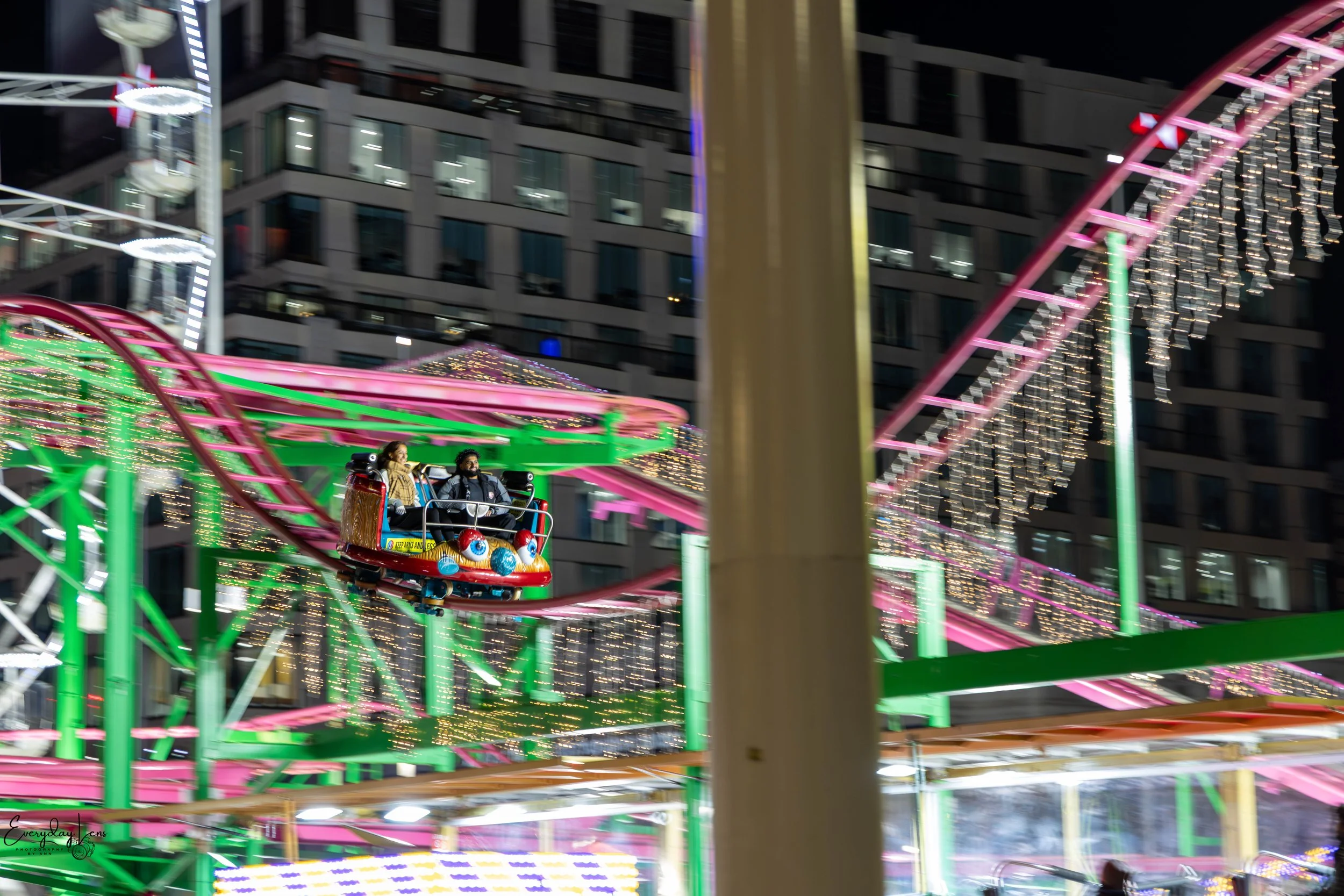 Bright lights and motion on a nighttime fairground ride