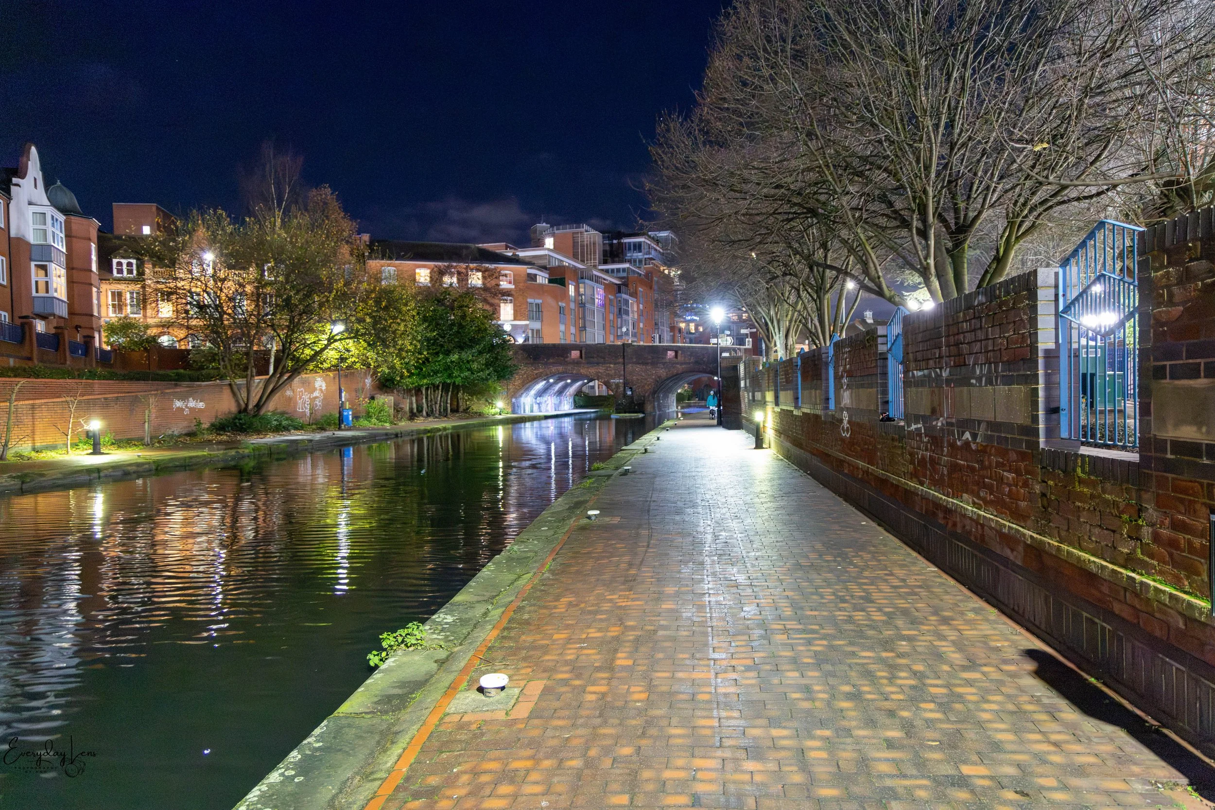 City lights reflected on a quiet canal at night