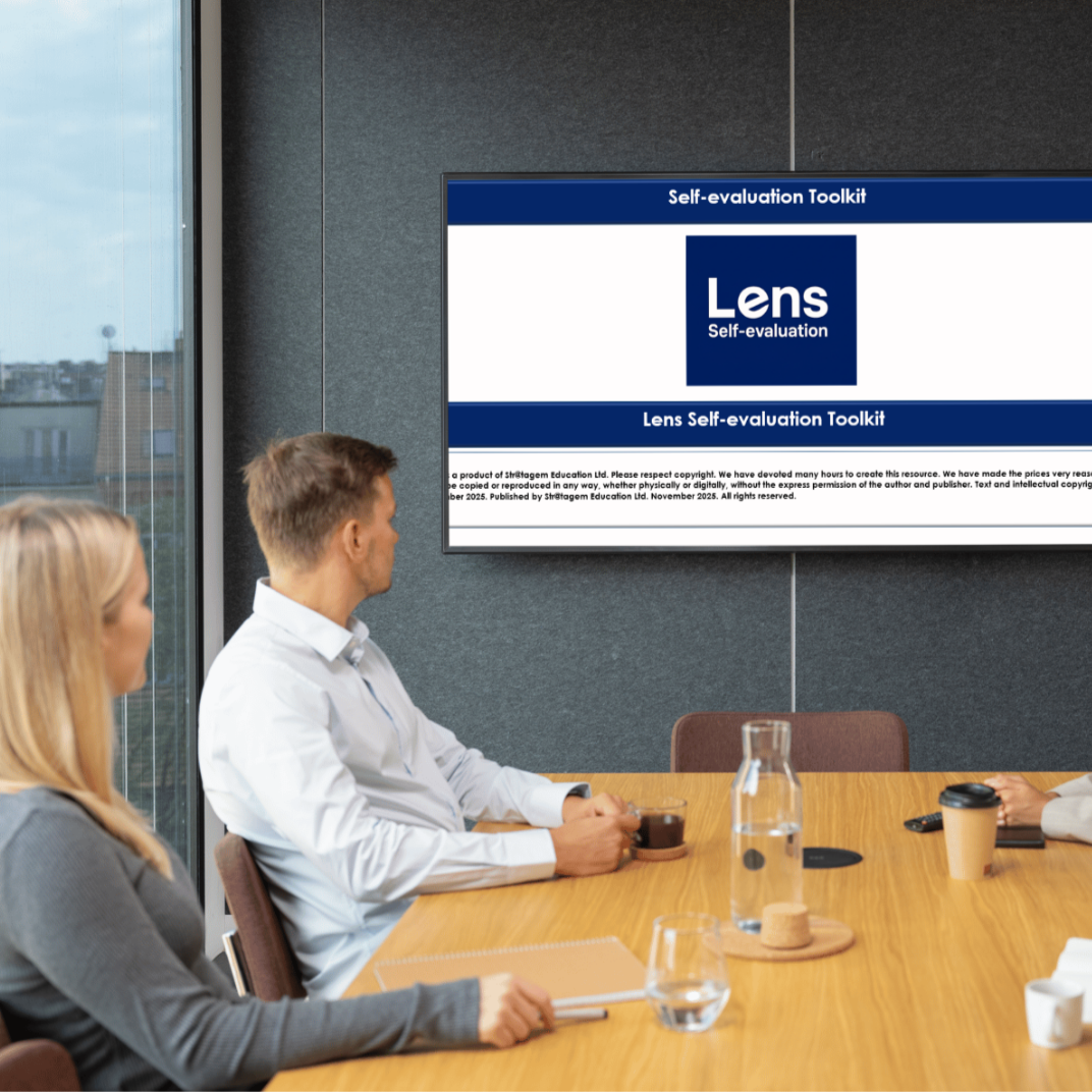 People attending a meeting in a conference room with a large screen displaying a self-evaluation toolkit titled 'Lens'.