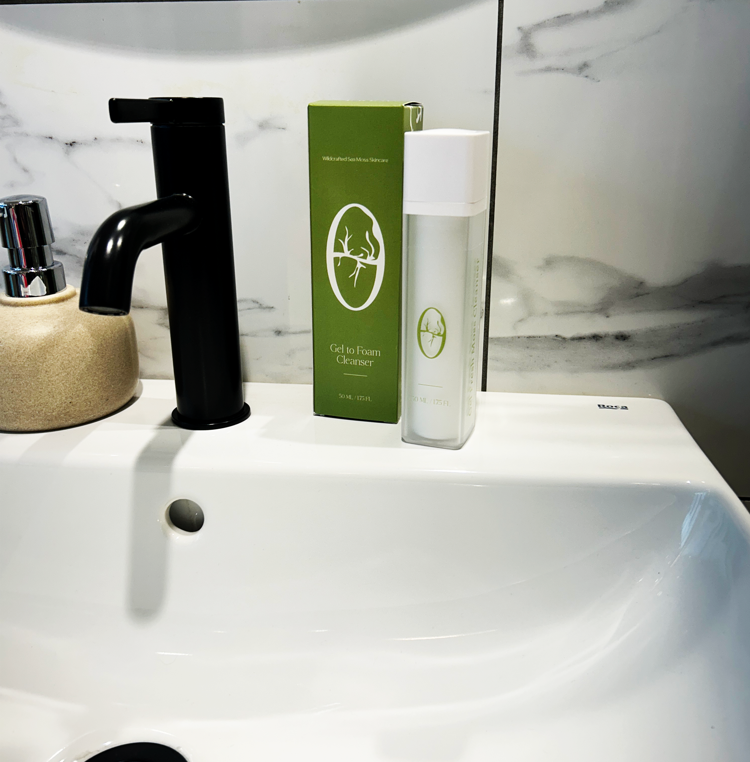 cleanser and packaging angled on sink