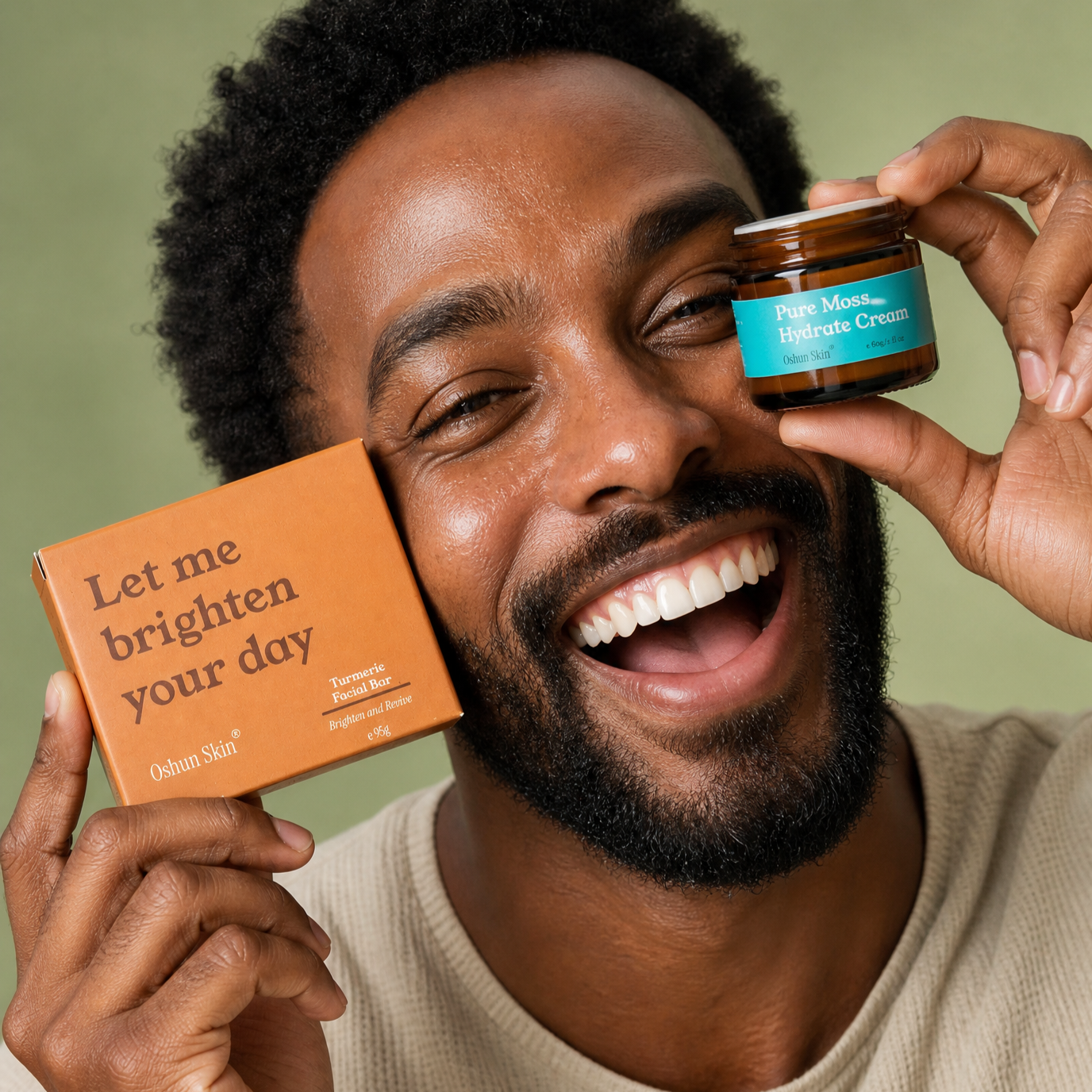 A+man+mid+thirties+with+deep_+rich-toned+glowing+skin+laughing+openly%2C+holding+Turmeric+Soap+Box++and+the+Pure+Moss+Hydrate+Cream.png