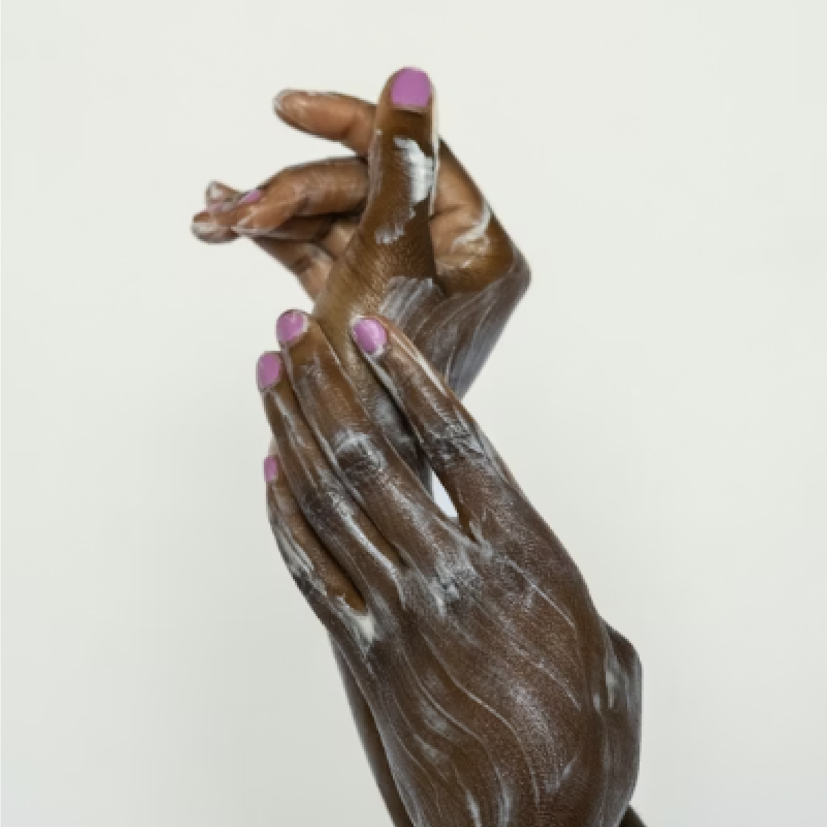 Black woman's hands lathering soap between hands and wrists