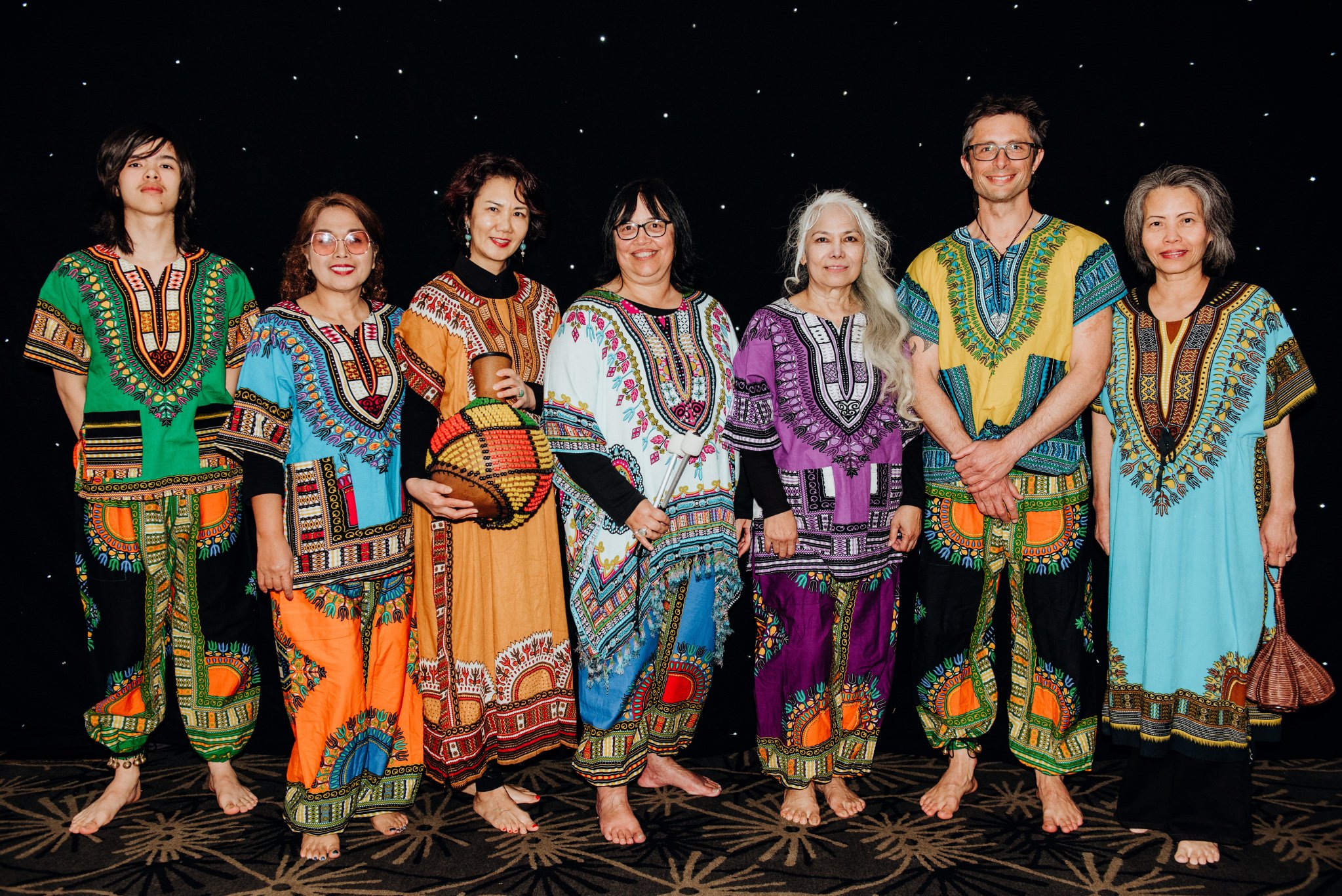 AFINCA drummers pose after their performance in colorful African-inspired robes.