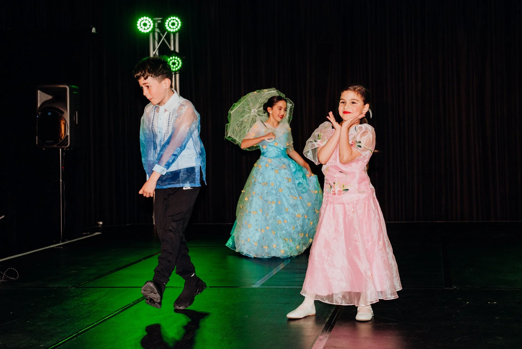 The youngest members of the Filipino modeling troupe pose with personality in their fancy outfits.