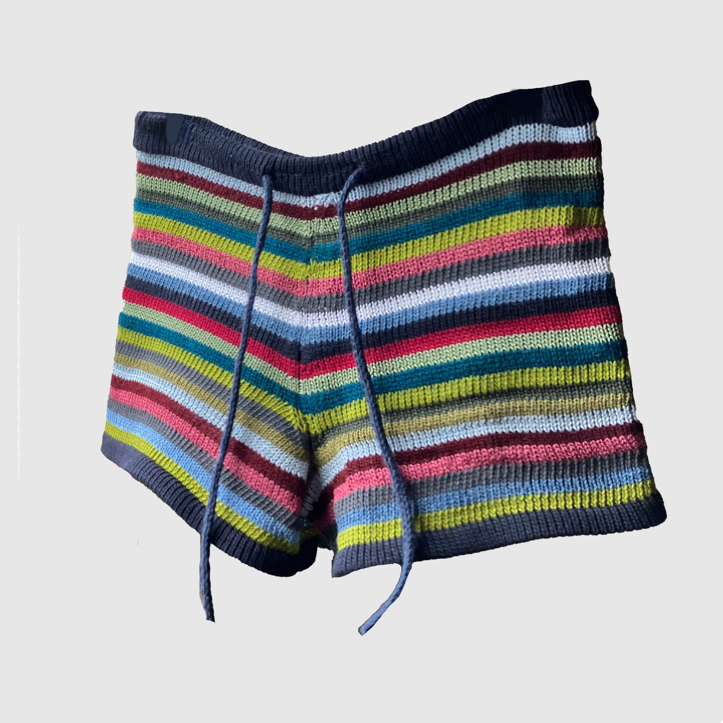 Colourful striped knitted shorts with a stretchy waistband and drawstring tie, handmade Y2K-inspired boho hippy fairycore design for girly fashion fans.