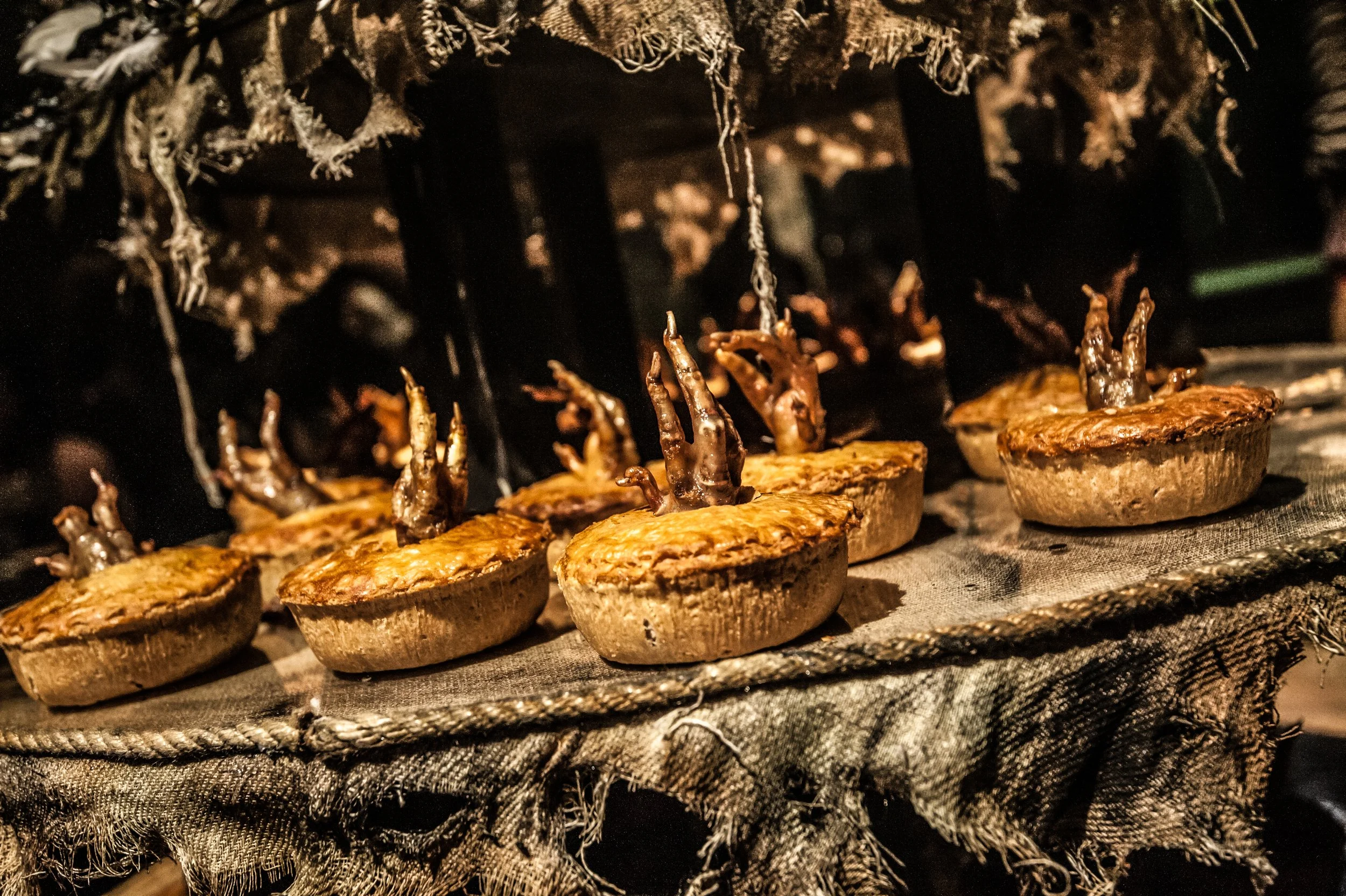 Mushrooms being cooked in a wood stove oven with a cloth covering at the edge.