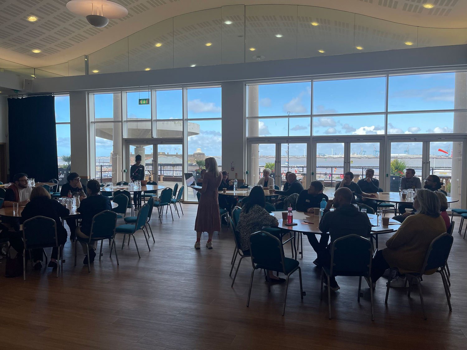 A photo of Emma running a client workshop.