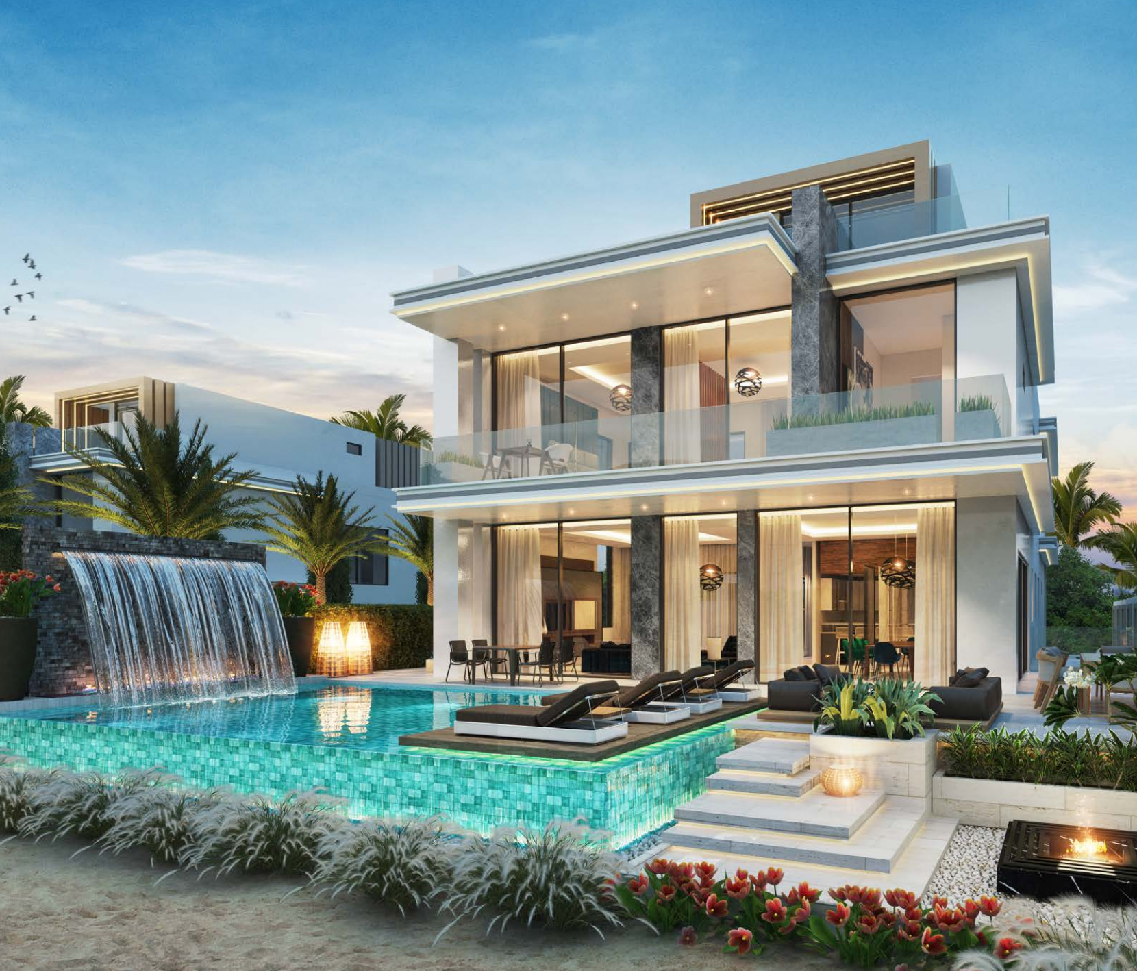 Luxury modern house with a large swimming pool, waterfall feature, lounge chairs, palm trees, and outdoor seating area, during twilight.