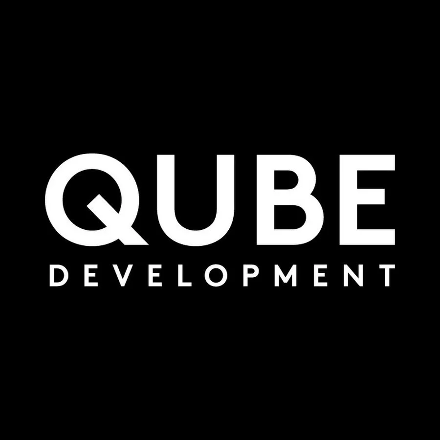 Logo for QUBE Development with white text on a black background