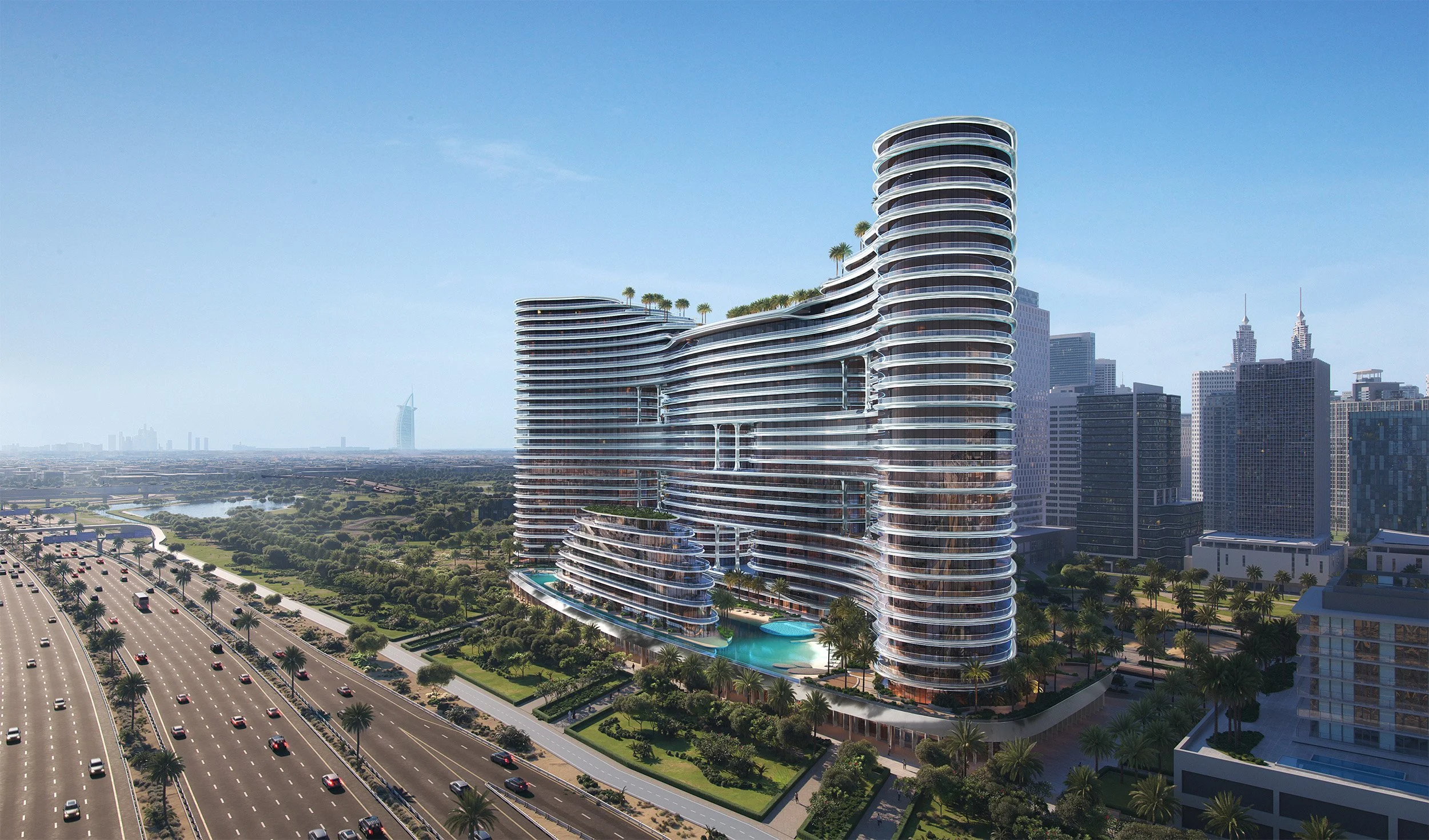 Modern high-rise building with curved glass balconies and rooftop greenery, set in an urban skyline with other high-rise buildings, a highway with cars, and a park with trees and a river in the distance under a clear blue sky.