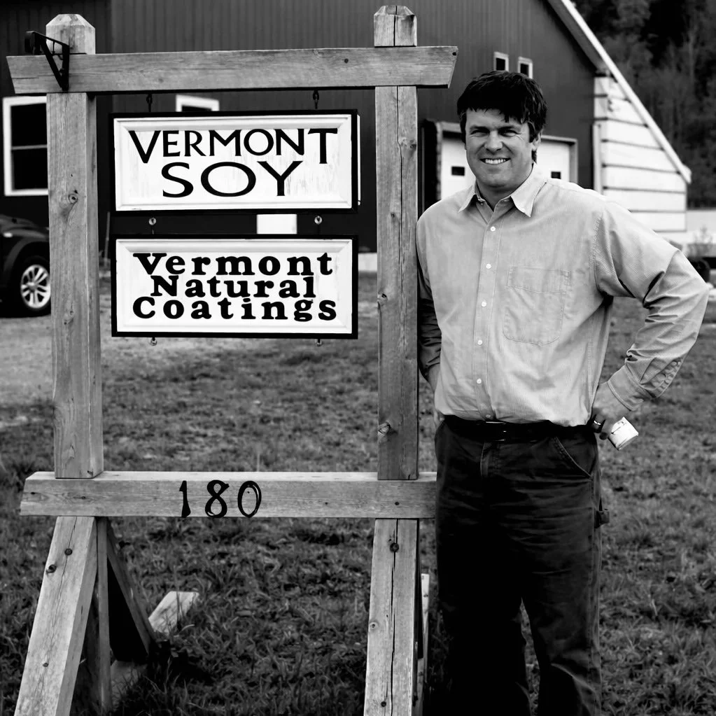 Andrew Meyer, founder of Vermont Natural Coatings, pictured outside the company's original Vermont facility — the working landscape that shaped the company's farm-rooted beginnings.