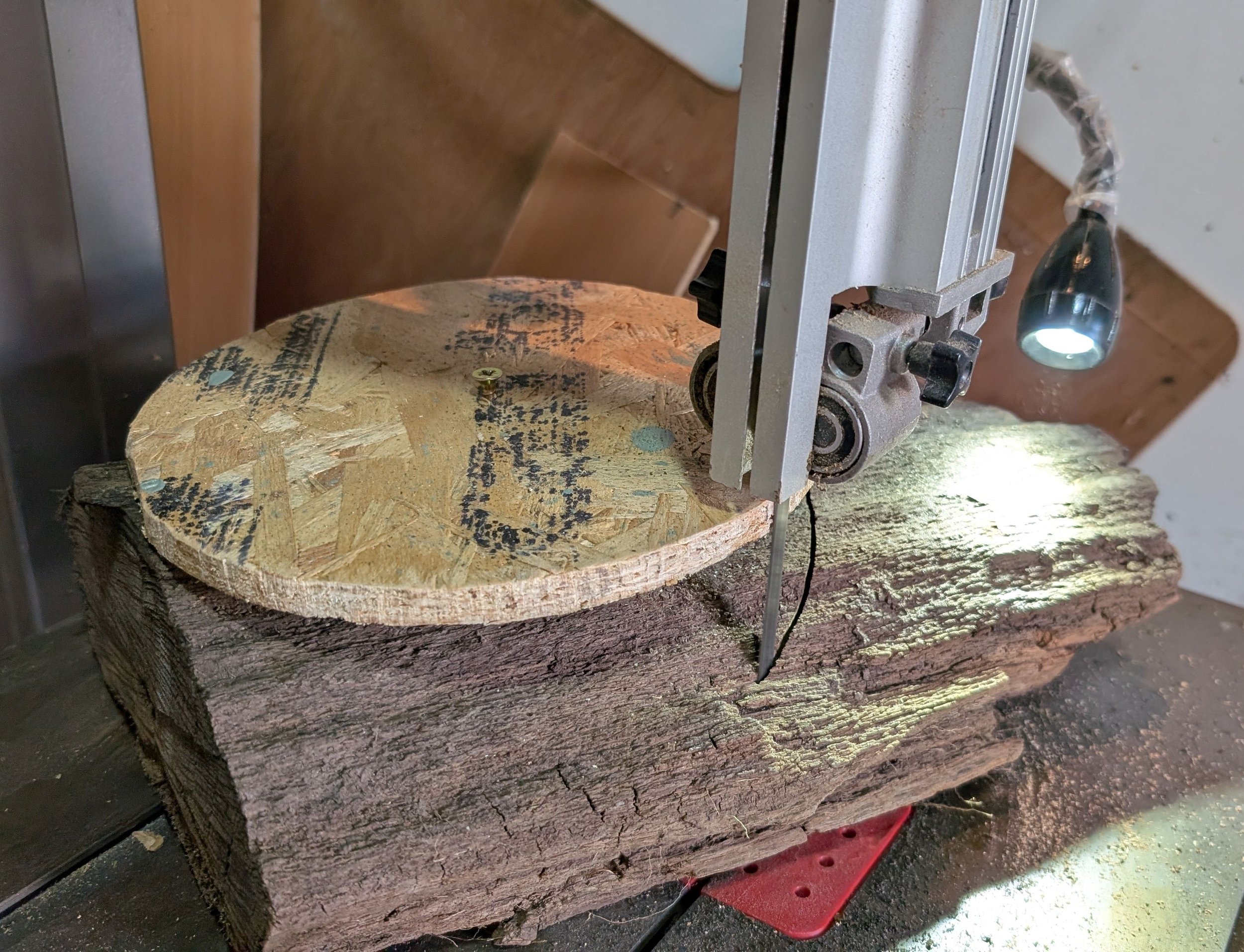 Cutting a round blank on the bandsaw, using a loosely attached template