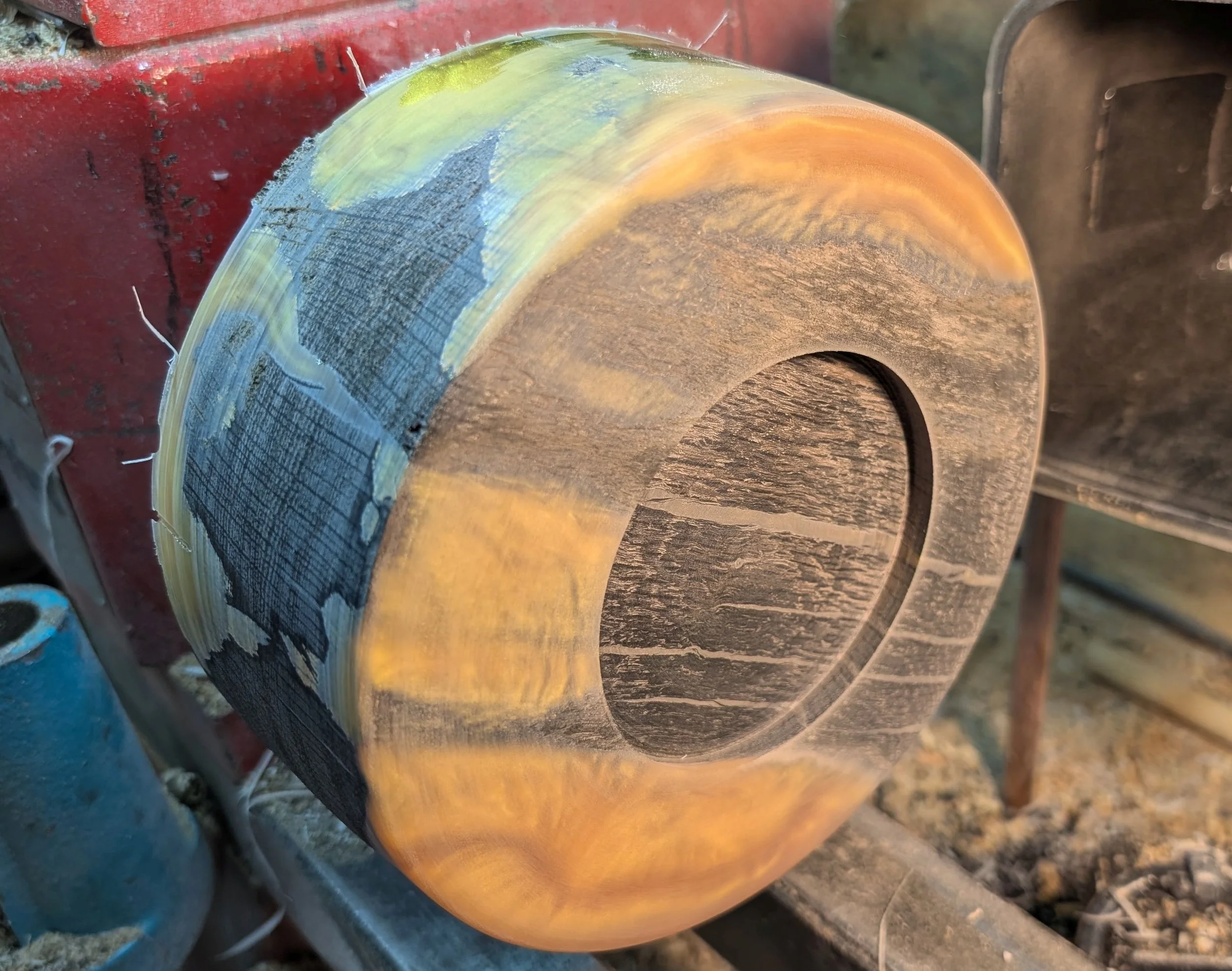 The blank is mounted in the chuck with a faceplate. This enables the bottom to be turned and the mortice cut to allow reverse mounting and the hollowing to begin