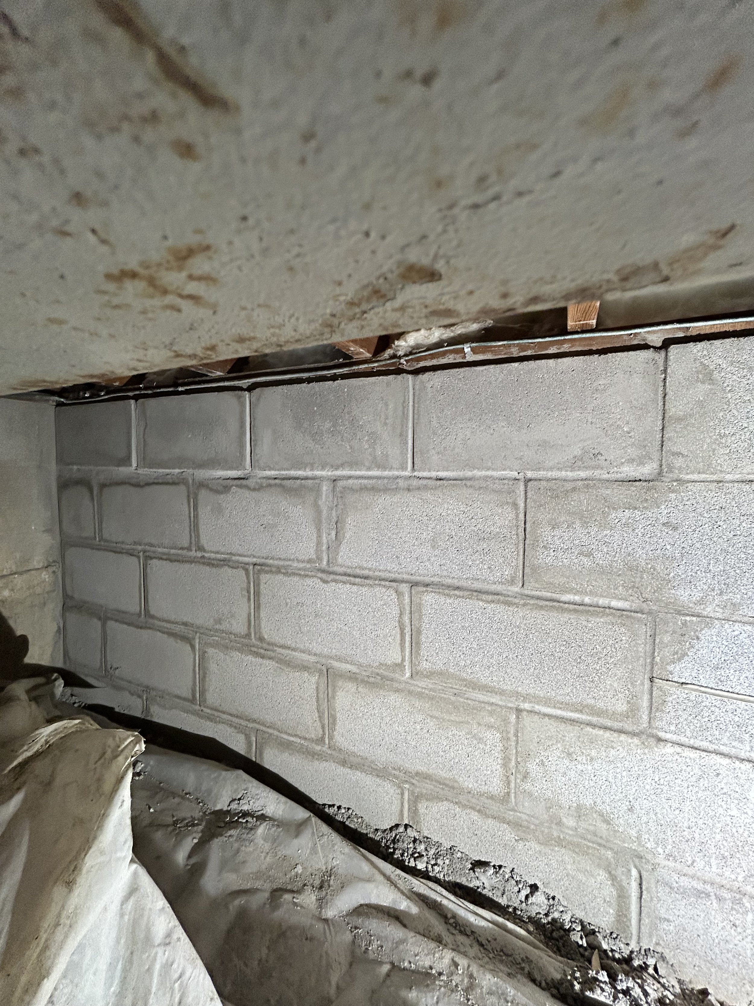 Helical piers and rebuilt CMU wall