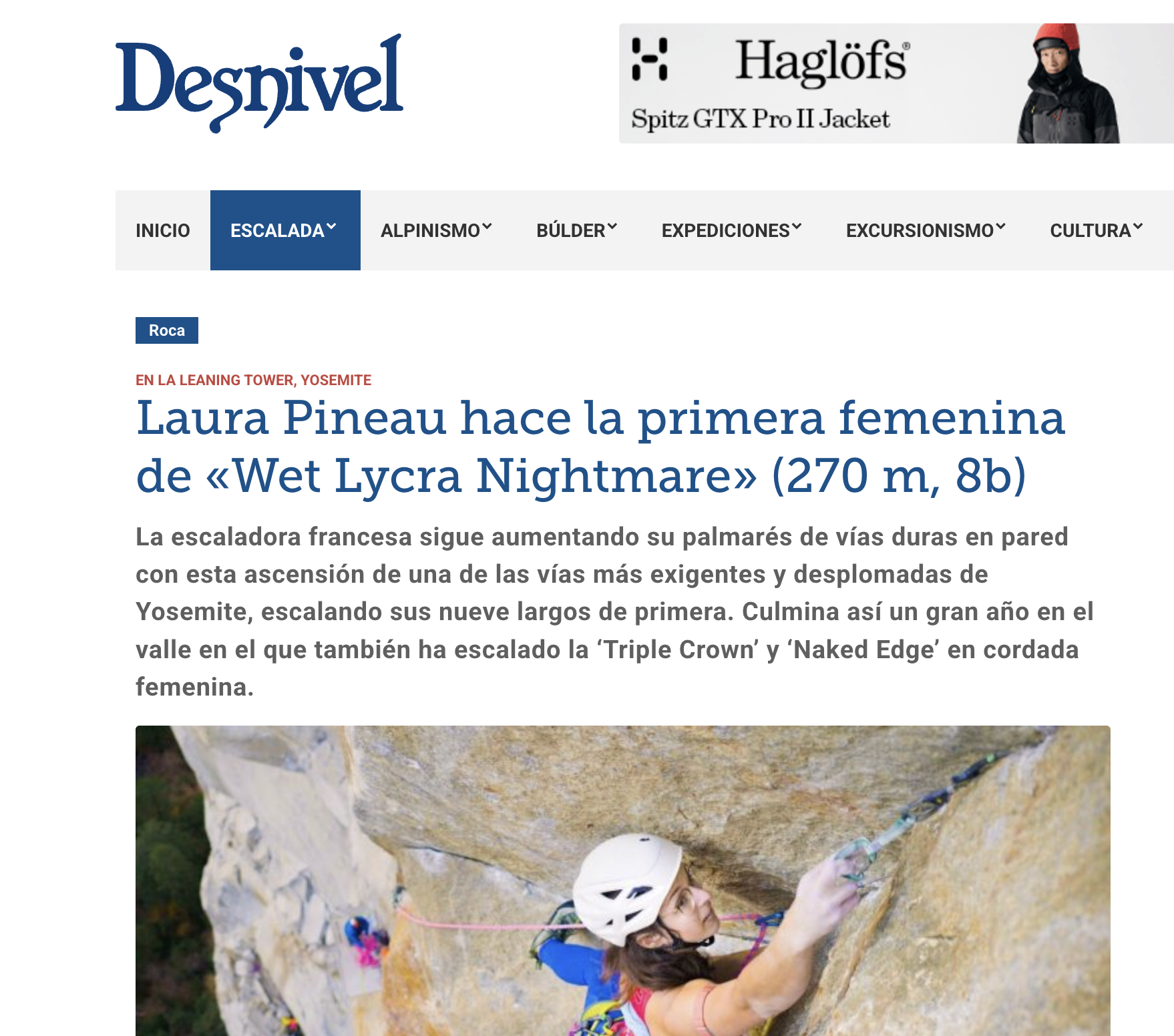 A woman wearing a safety helmet rock climbing on a steep outdoor cliff, using a harness and safety ropes.