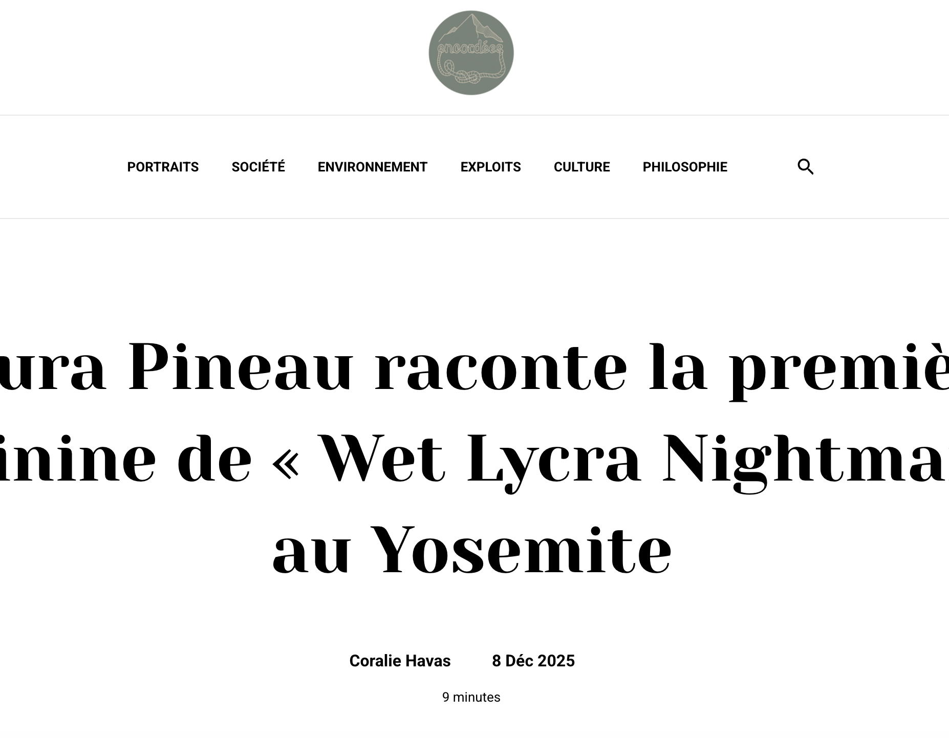 Climber ascending a steep rock face with mountains and trees in the background