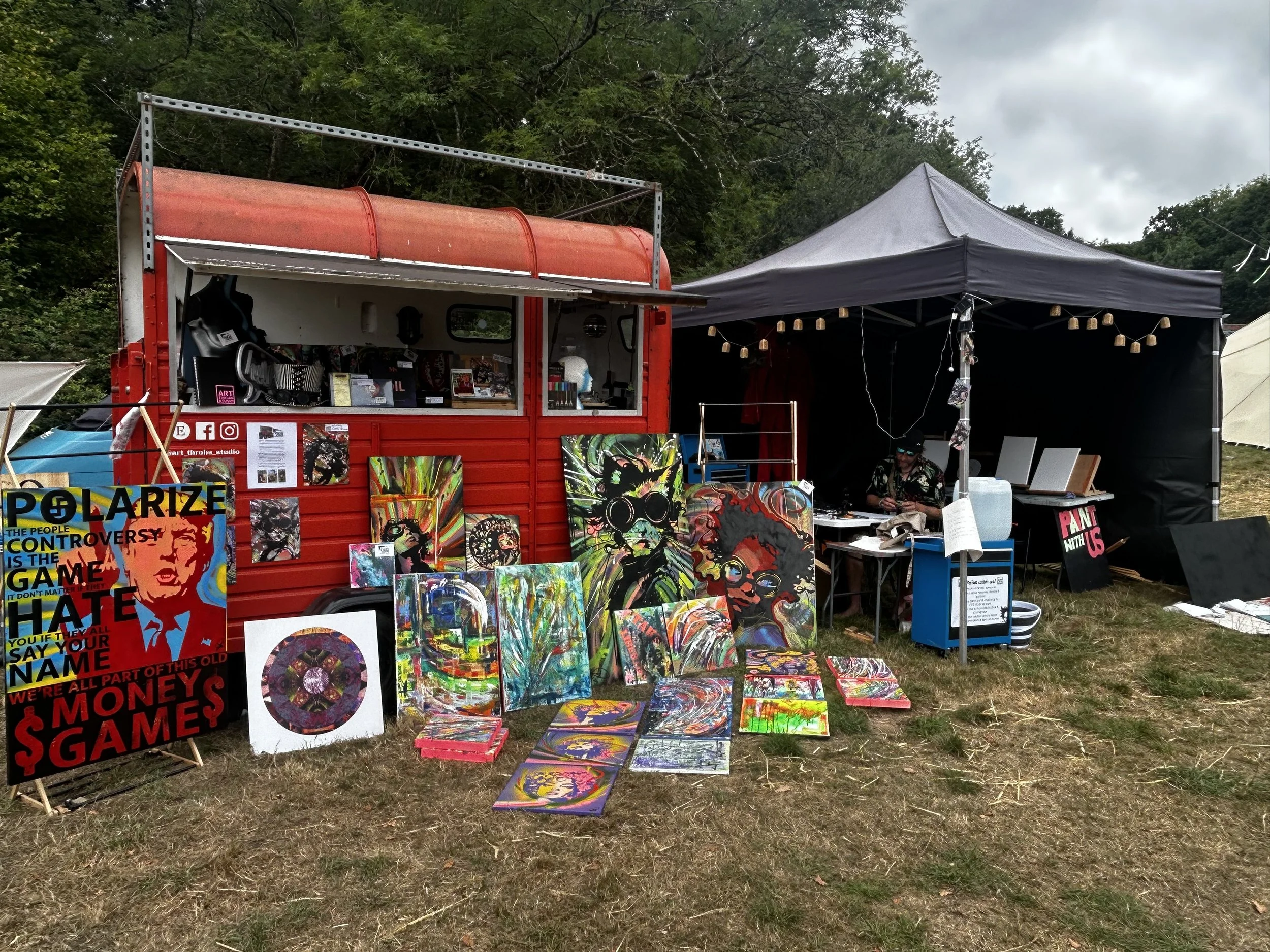An art studio in a converted horse box surrounded with paintings