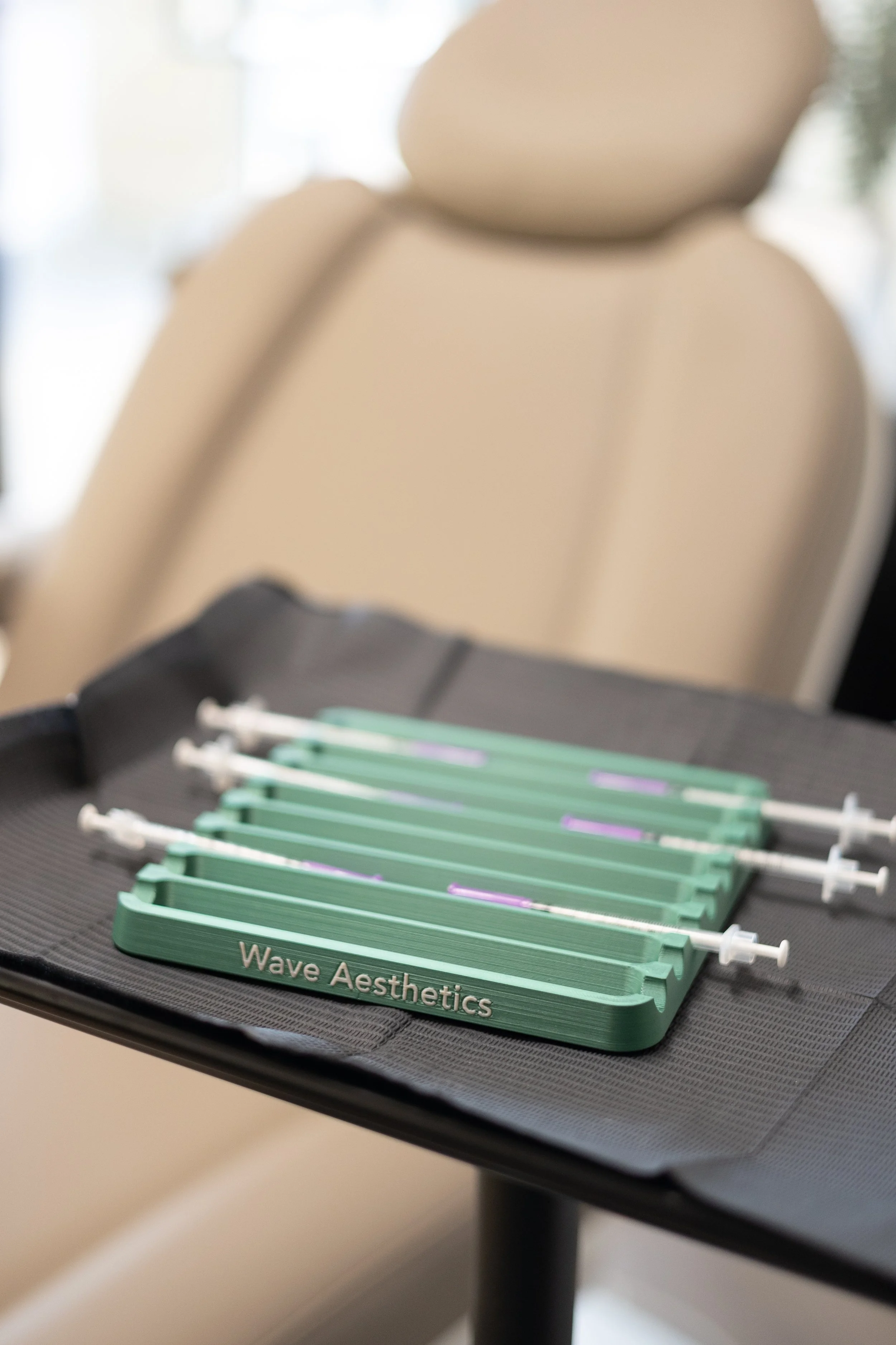 Organized tray of syringes and injectable supplies prepared for aesthetic treatments in a medical spa setting at Wave Aesthetics.