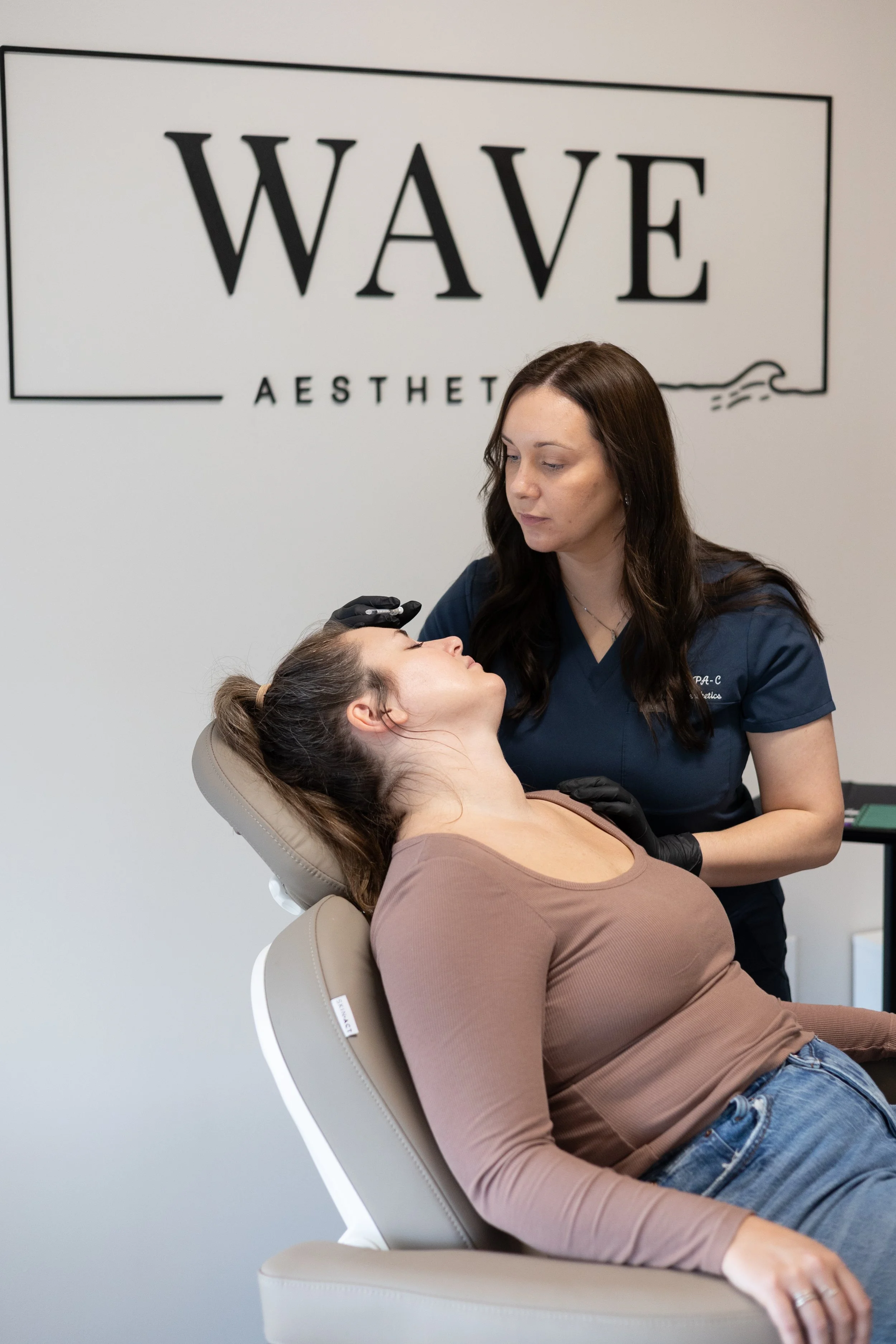 Chelsea injecting a patient with Botox at Wave Aesthetics in Ann Arbor during a facial rejuvenation treatment.