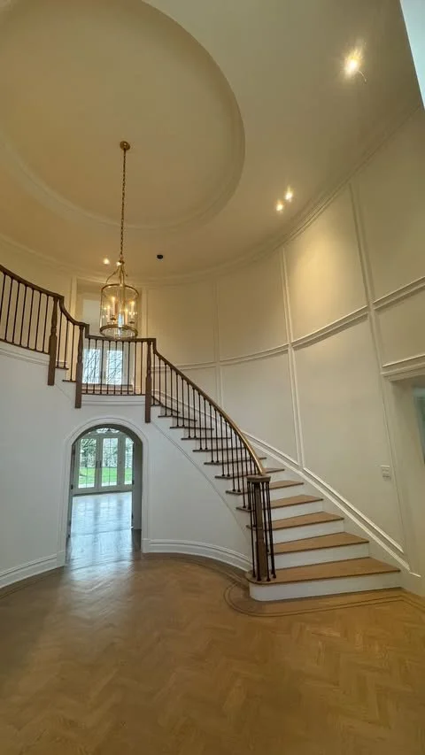 Grand curved staircase and rotunda ceiling after full gut renovation in Cresskill, NJ