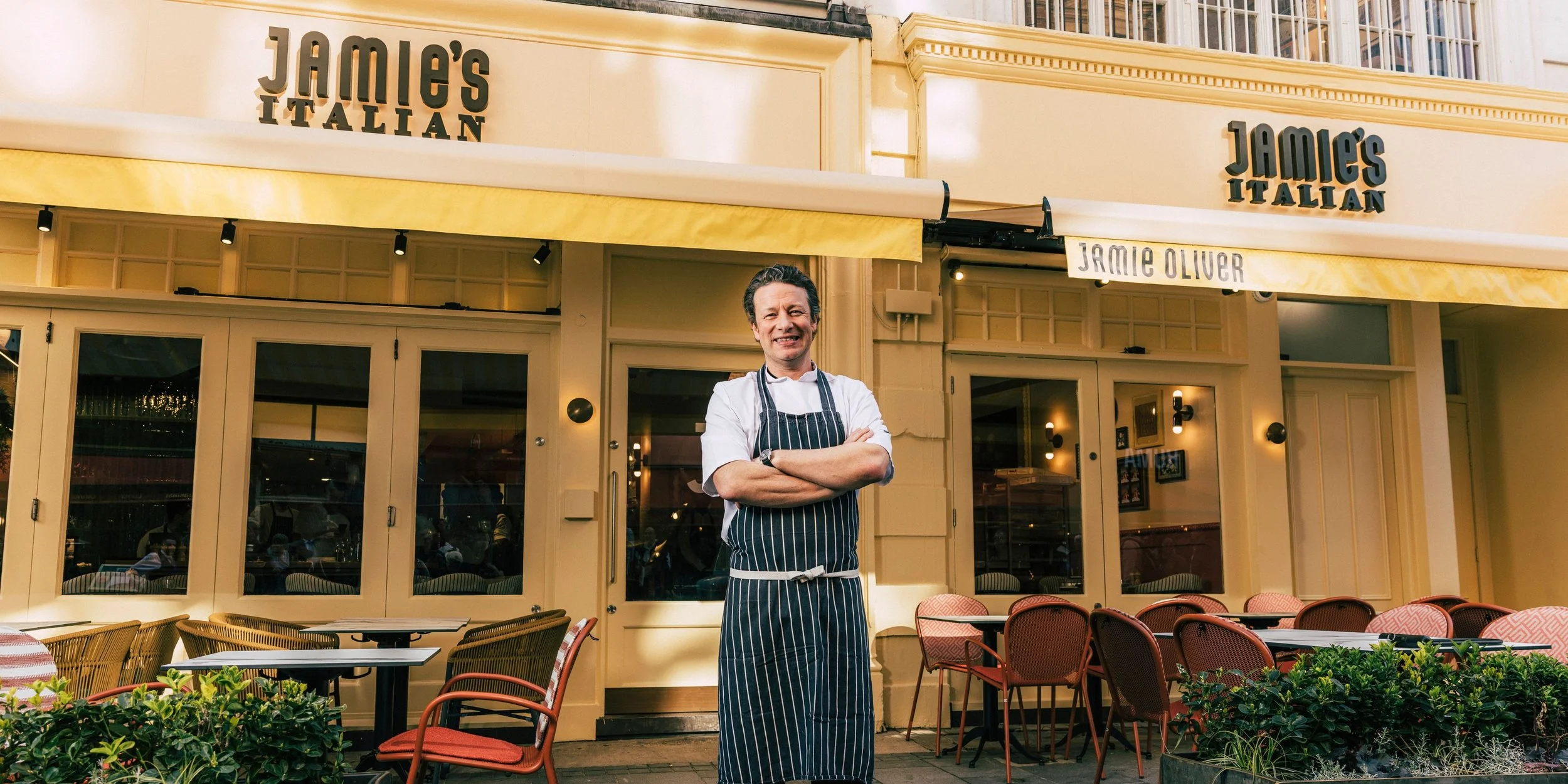 Jamie Oliver standing outside the restaurant