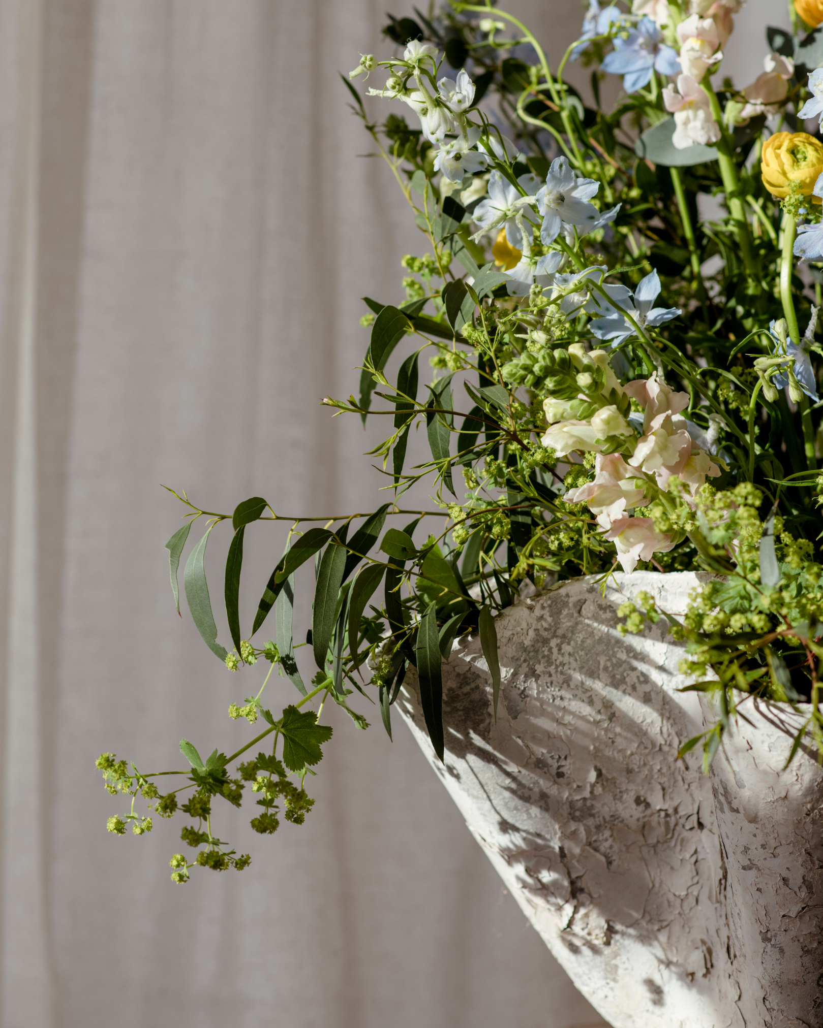 a Willy Guhl tissue planter with green foliage