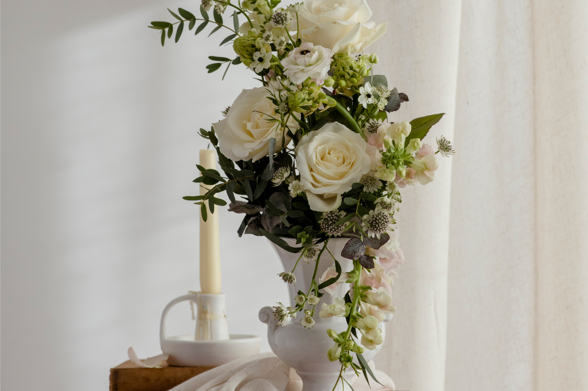 a traditional white wedding with a modern floral design using large white roses