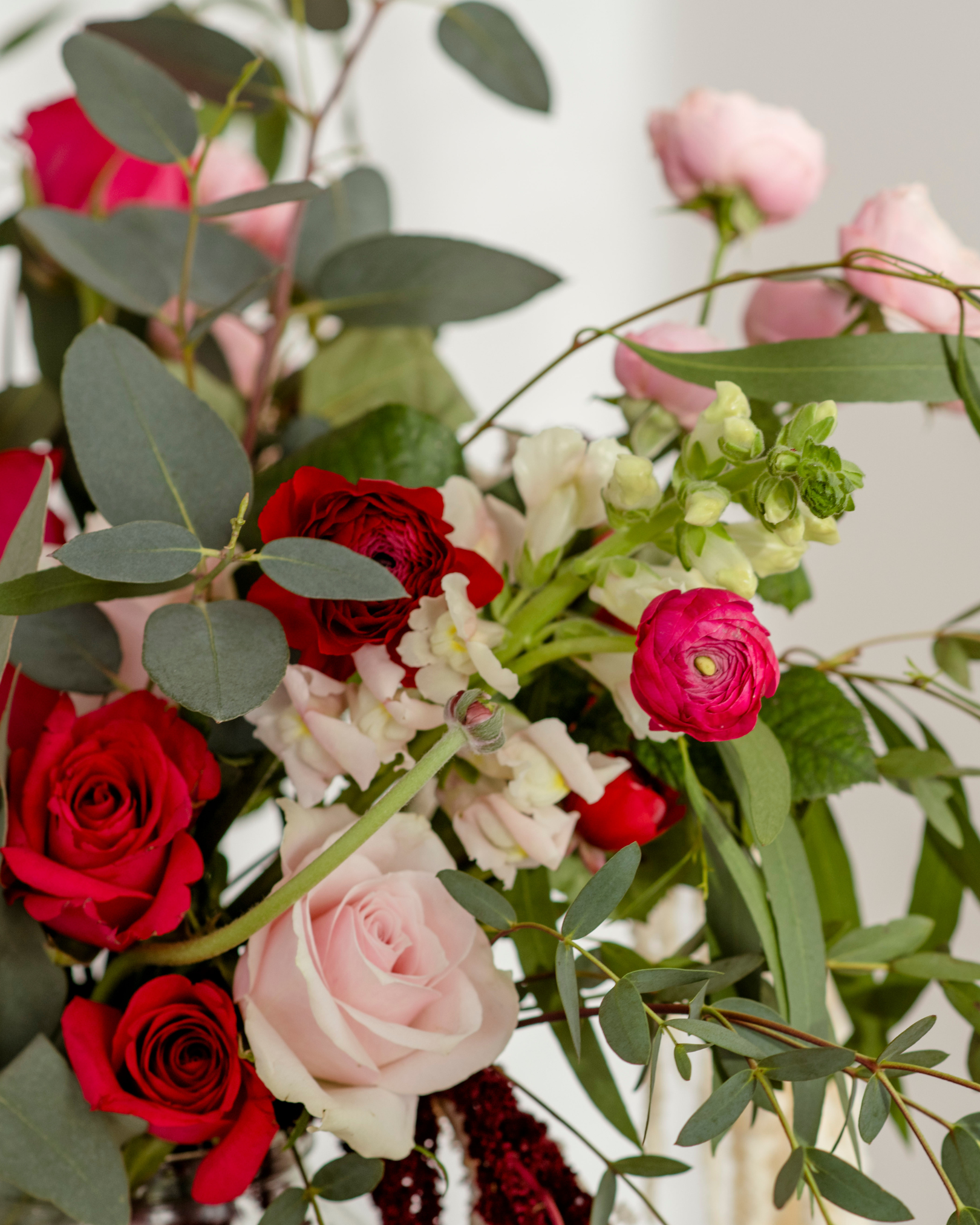 red and pink roses in a bridal bouquet
