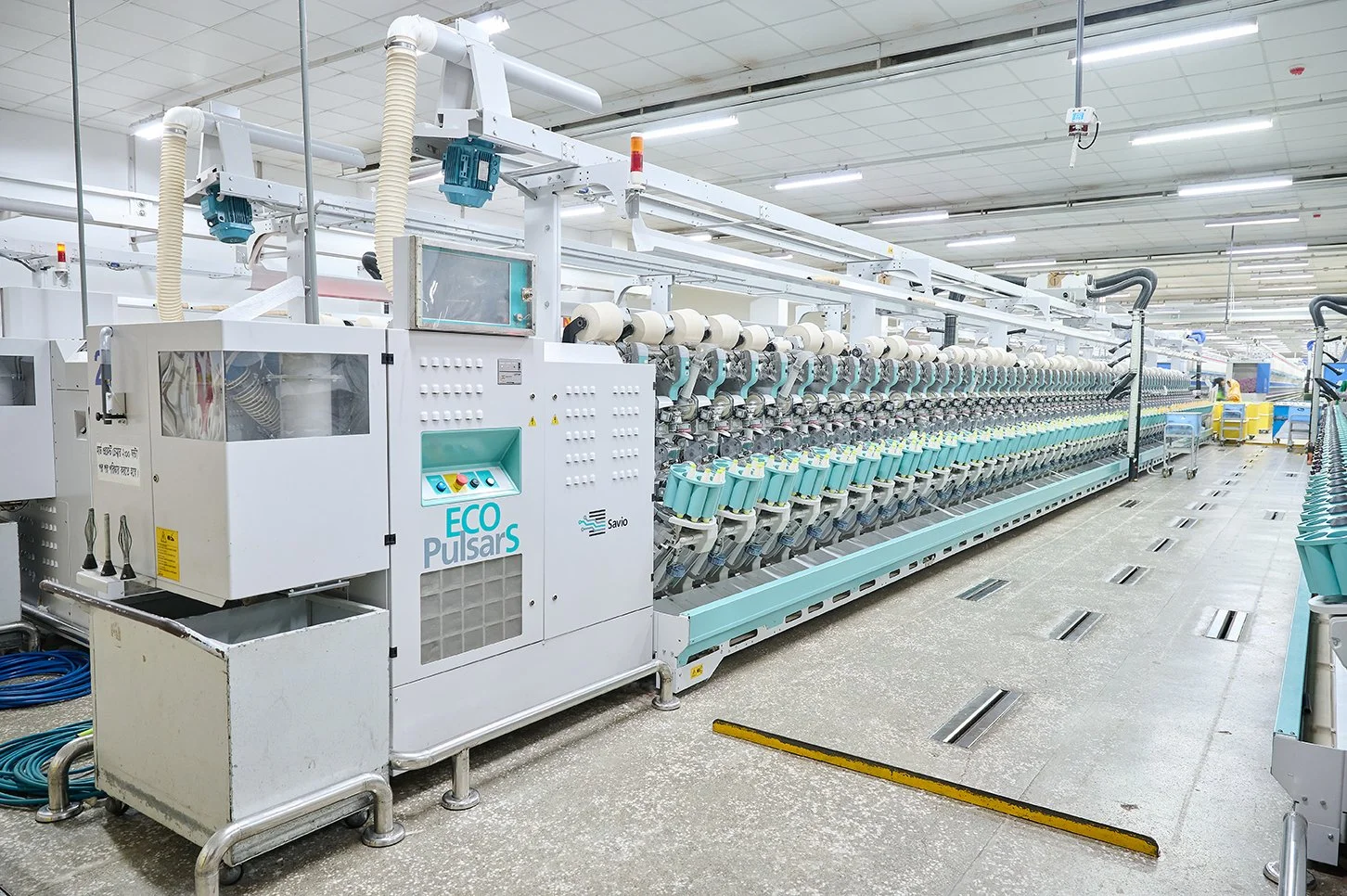 Industrial textile manufacturing machine in a factory setting.