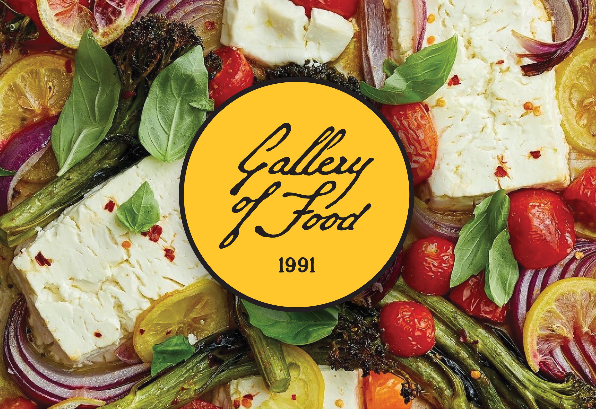 A close-up image of various fresh vegetables and cheeses, with a yellow circle in the center featuring the text 'Gallery of Food 1991' in black script.