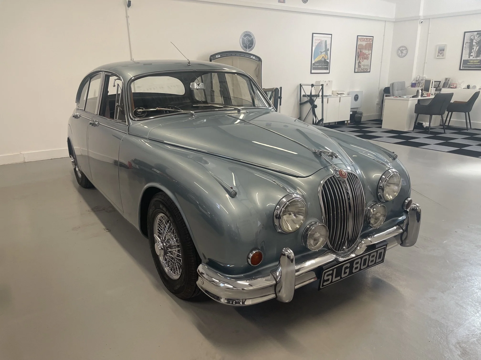 Jaguar mk2 in silver blue for sale in a showroom