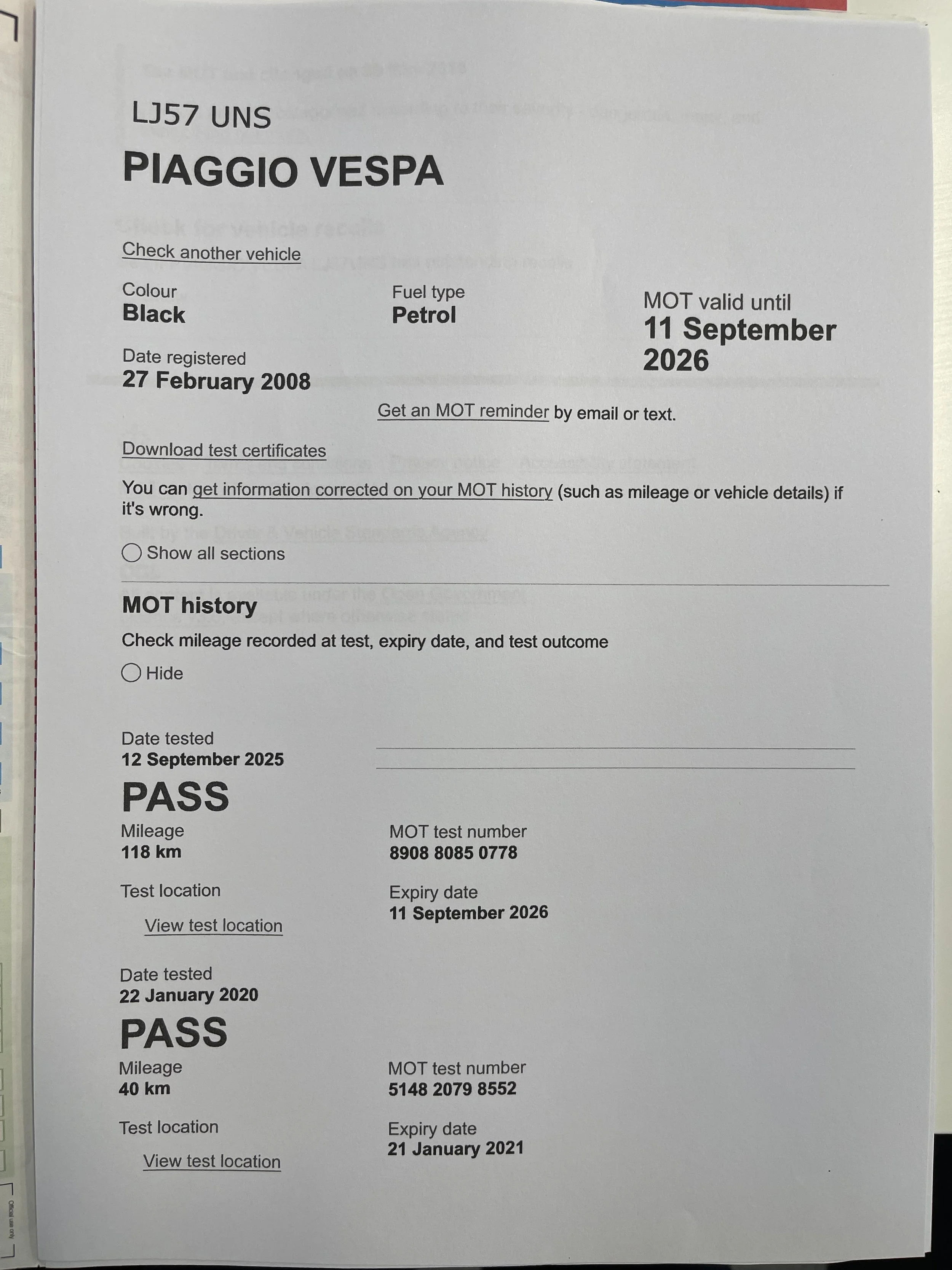 Vespa in black shown in a car showroom