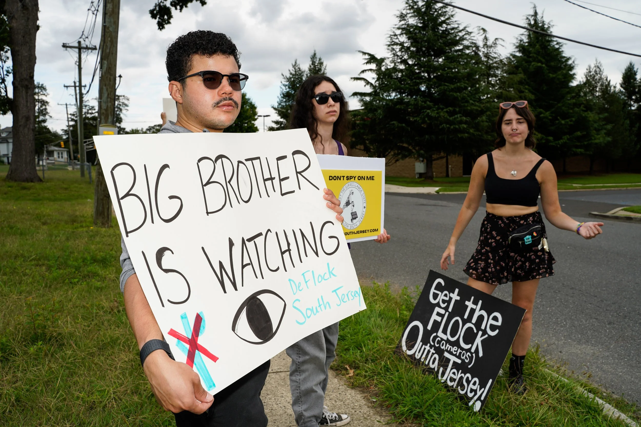 David Montero, left, and Val Tobin, right, hold up signs at a protest by the new group, DeFlock South Jersey at a Lowe’s in Lawnside, New Jersey on Saturday, August 22, 2026. (NJ.com)