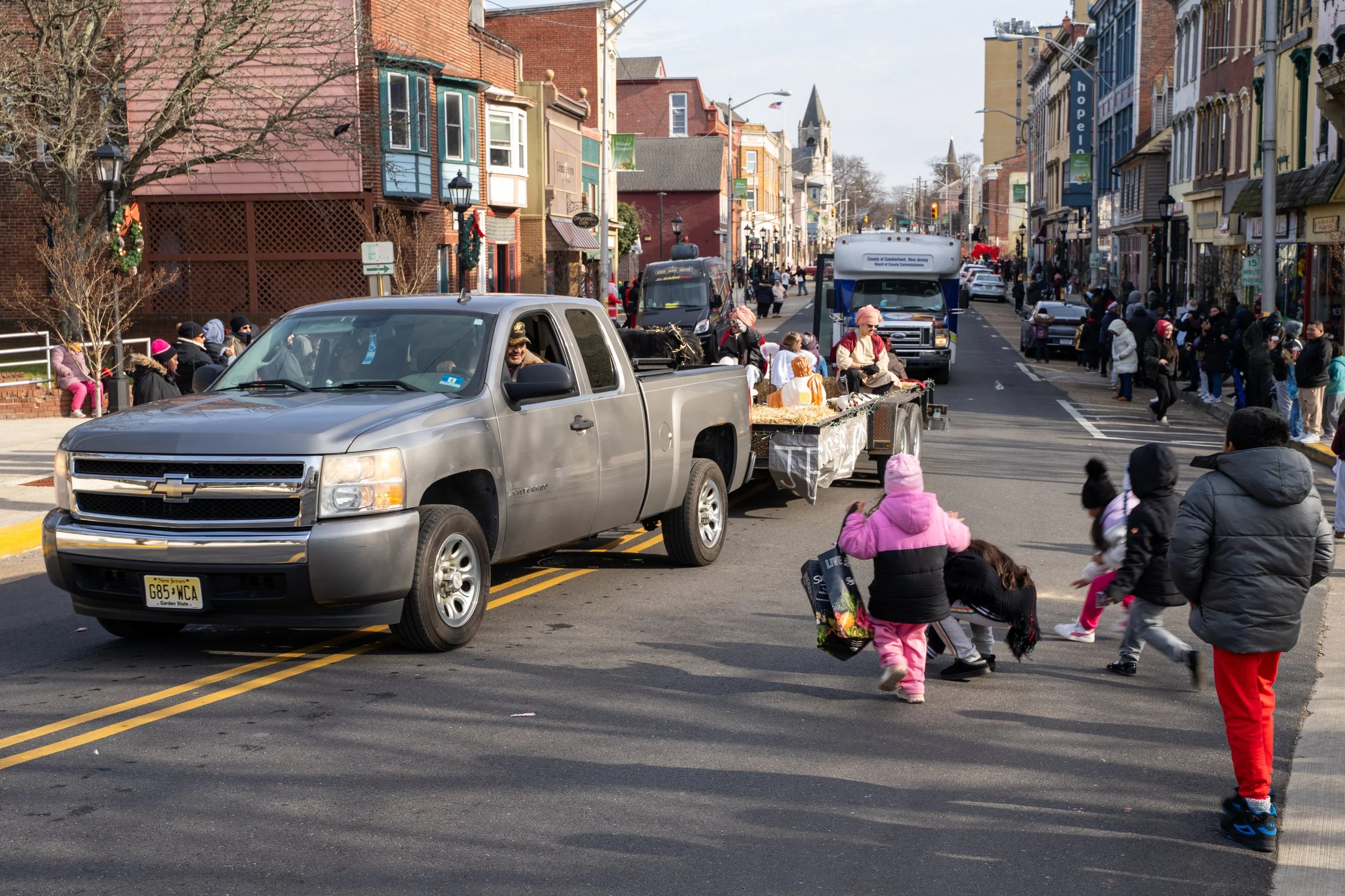Kids run into the street to grab candy that a float driver threw at the Bridgeton Holiday Parade in Bridgeton, NJ on Saturday, December 13, 2025. (Follow South Jersey)