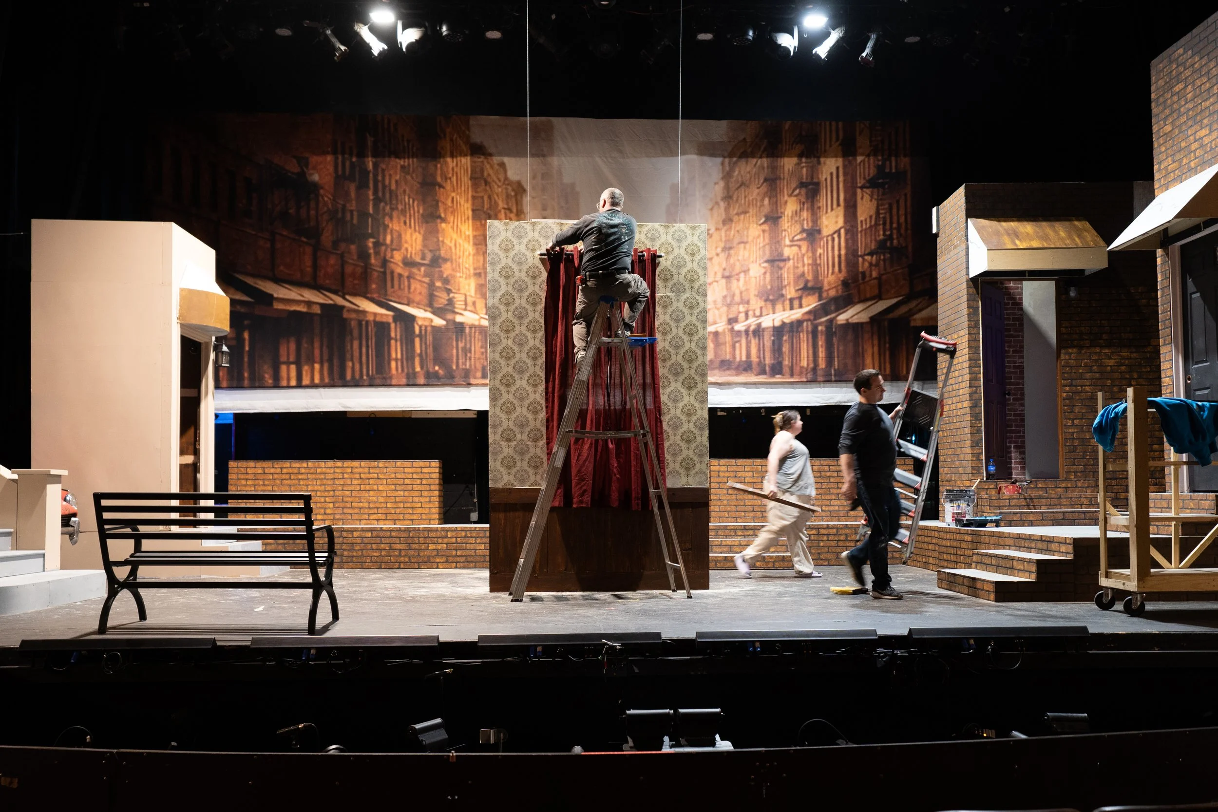 Glen Funkhouser, center, builds the set for "A Bronx Tale" with Andie Brooks, center right, and Mike Blood, right, at the Broadway Theatre in Pitman, New Jersey on Monday, April 20, 2026. (NJ.com)