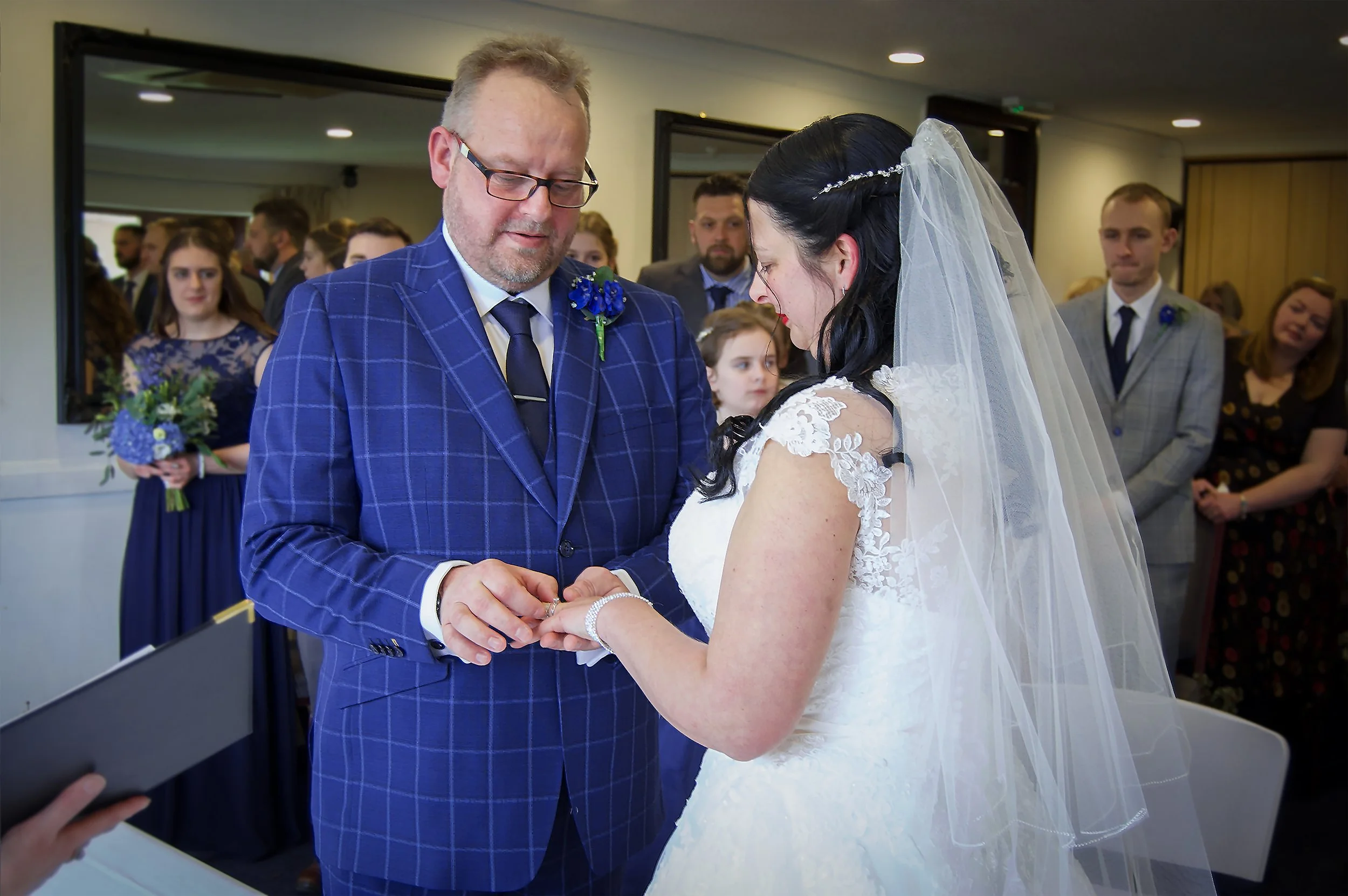 A bride and groom exchanging rings at the Goring & Streatley Gold club