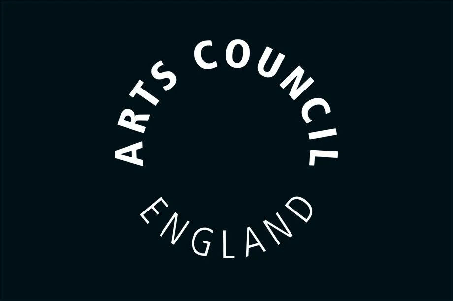 Logo of the Arts Council England, featuring bold, white text arranged in a circular design against a dark background.