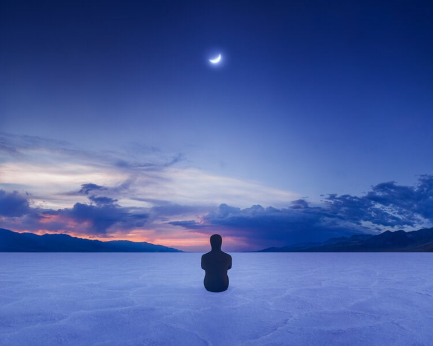 Colour photograph from Gabriel Isak of a figure in a black morph suit looking out at a blue sky