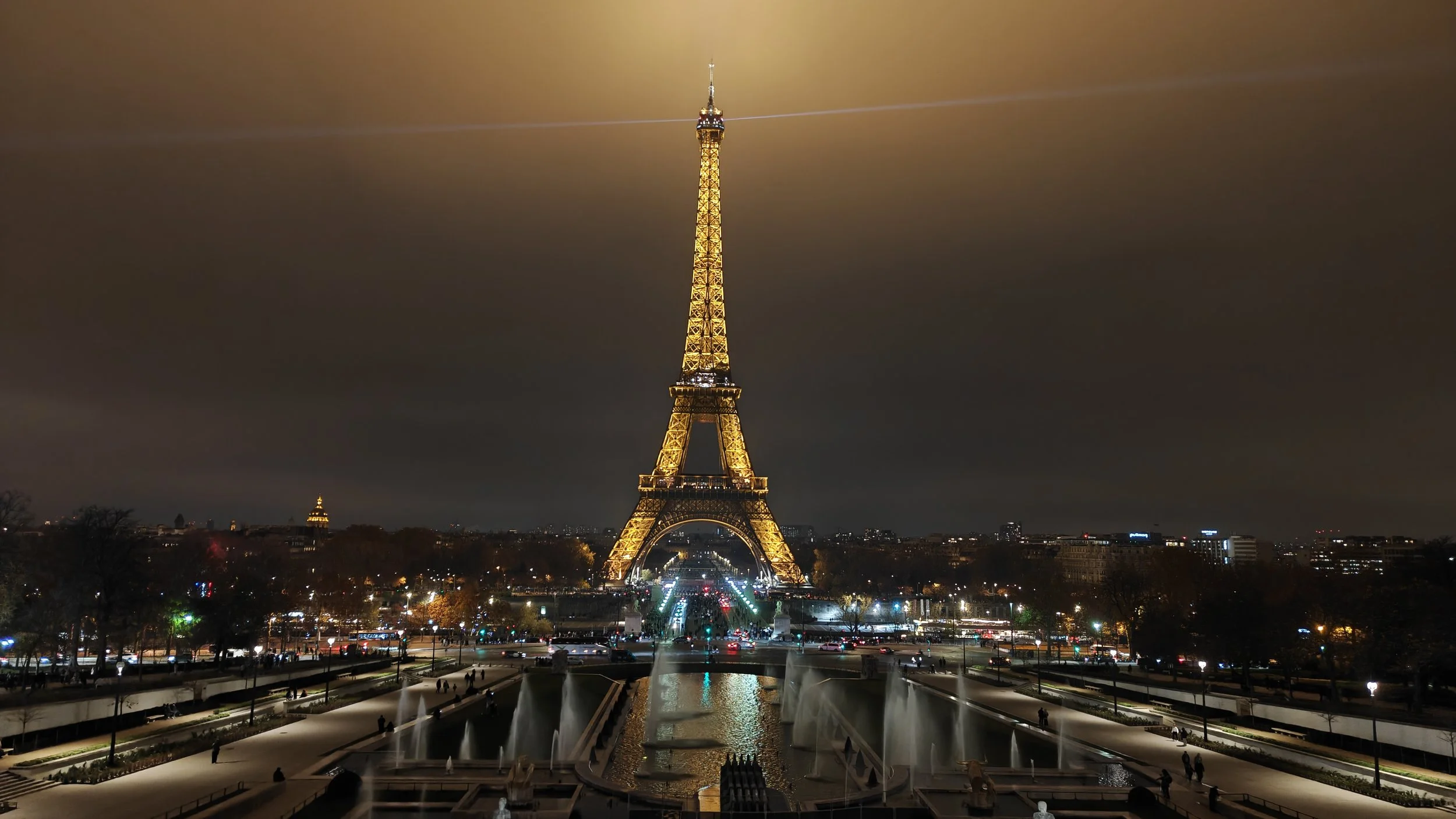 Evening photograph of the Eiffel Tower in Paris lit up.