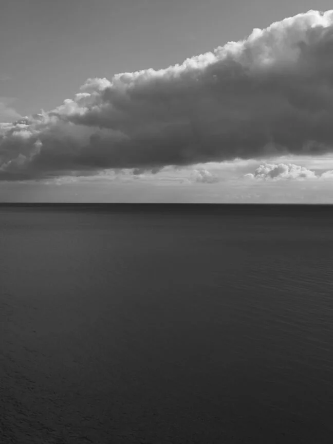 Black and White photograph from Loredana Nemes depicting a still body of water against a grey cloud