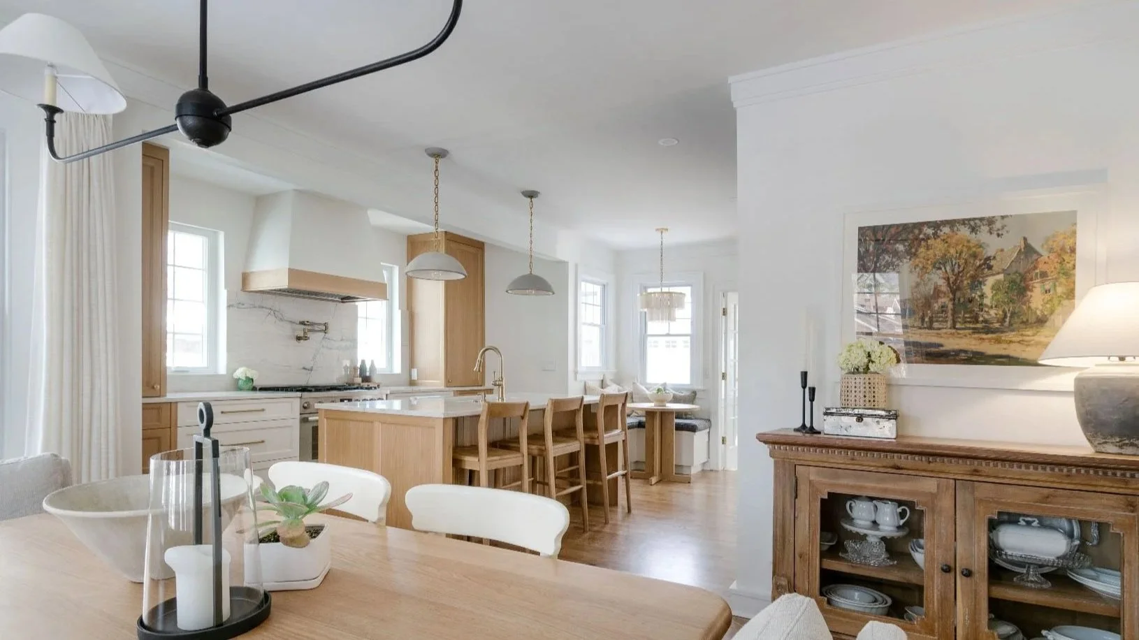 Whole-home remodel in Kansas City featuring an open kitchen, custom cabinetry, integrated dining area, and cohesive living space design by Erica Kay Design & Remodeling.