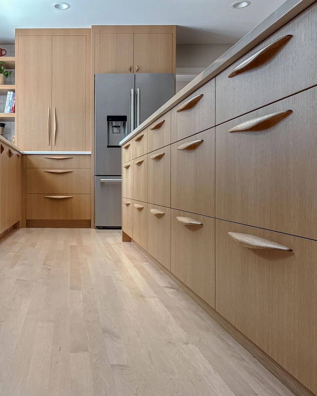 Rift-sawn white oak kitchen with modern wooden cabinet pulls in Prairie Village Kansas