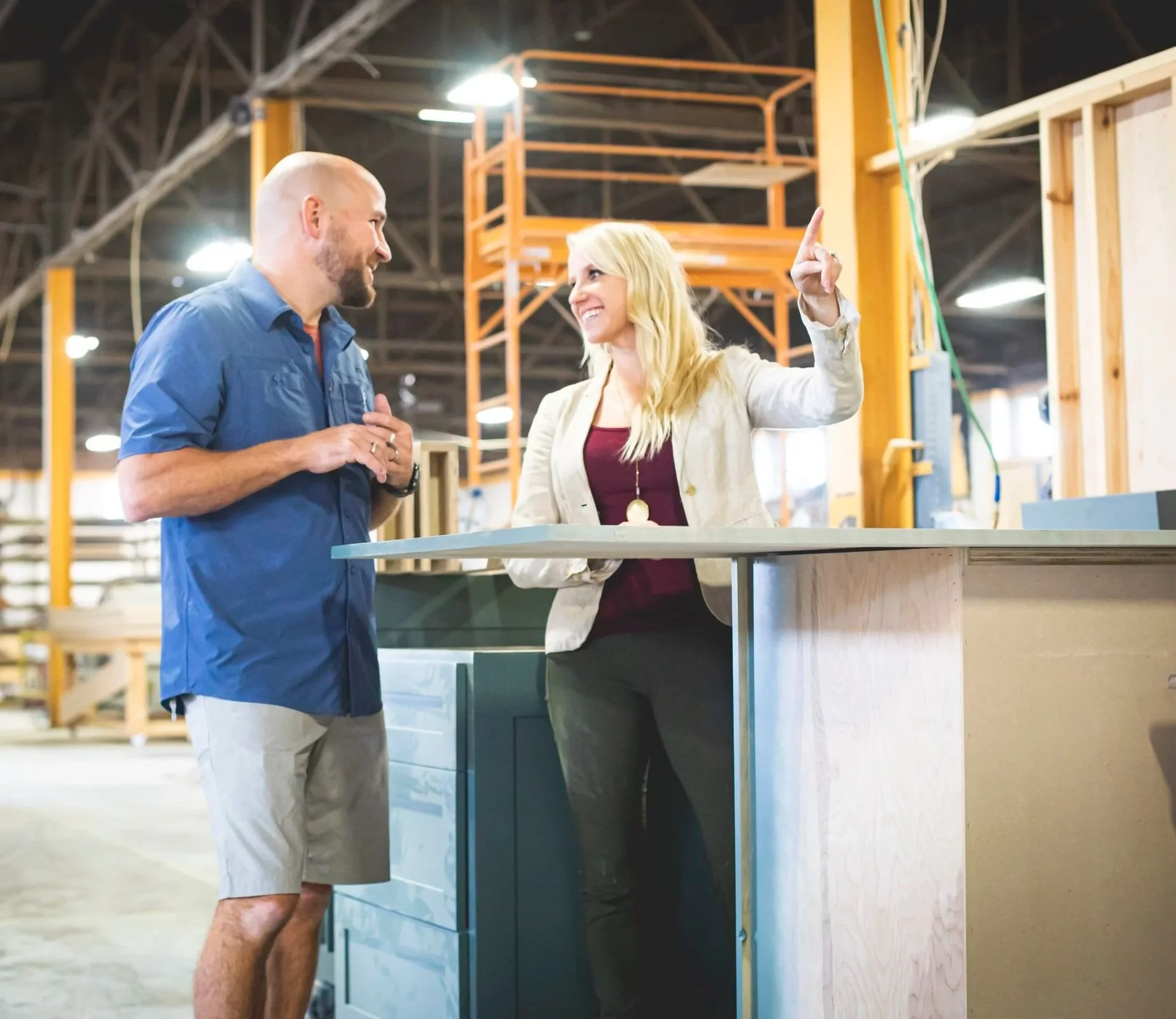 Interior designer Erica Kay Thowe collaborating with a local Kansas City custom cabinet maker in his woodworking shop to ensure precision and quality for a luxury kitchen remodel.
