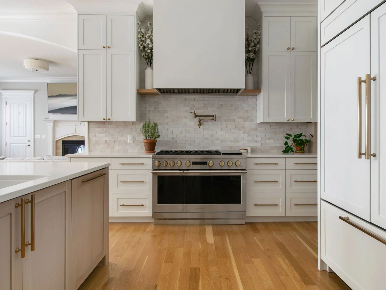 Pro-style range and pot filler framed by white cabinetry and a handmade Clé tile backsplash.