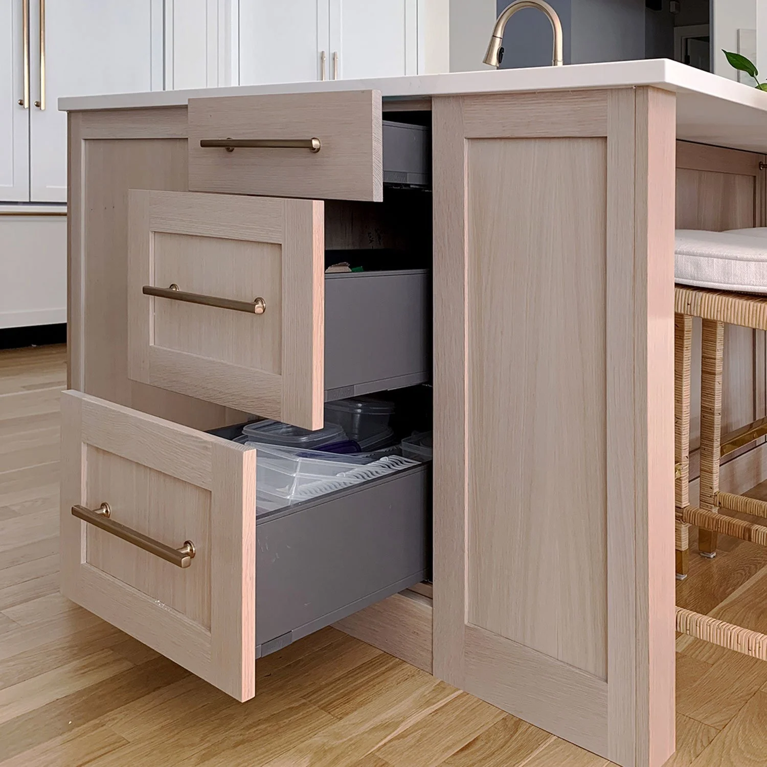 Custom white oak kitchen island cabinetry with built-in drawer storage designed by Erica Kay Design in Fairway, Kansas City