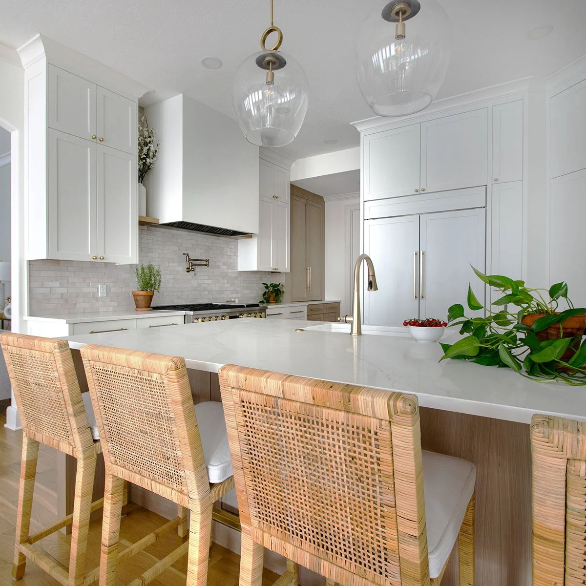 Plain-sawn white oak kitchen island with quartz countertops and seating.